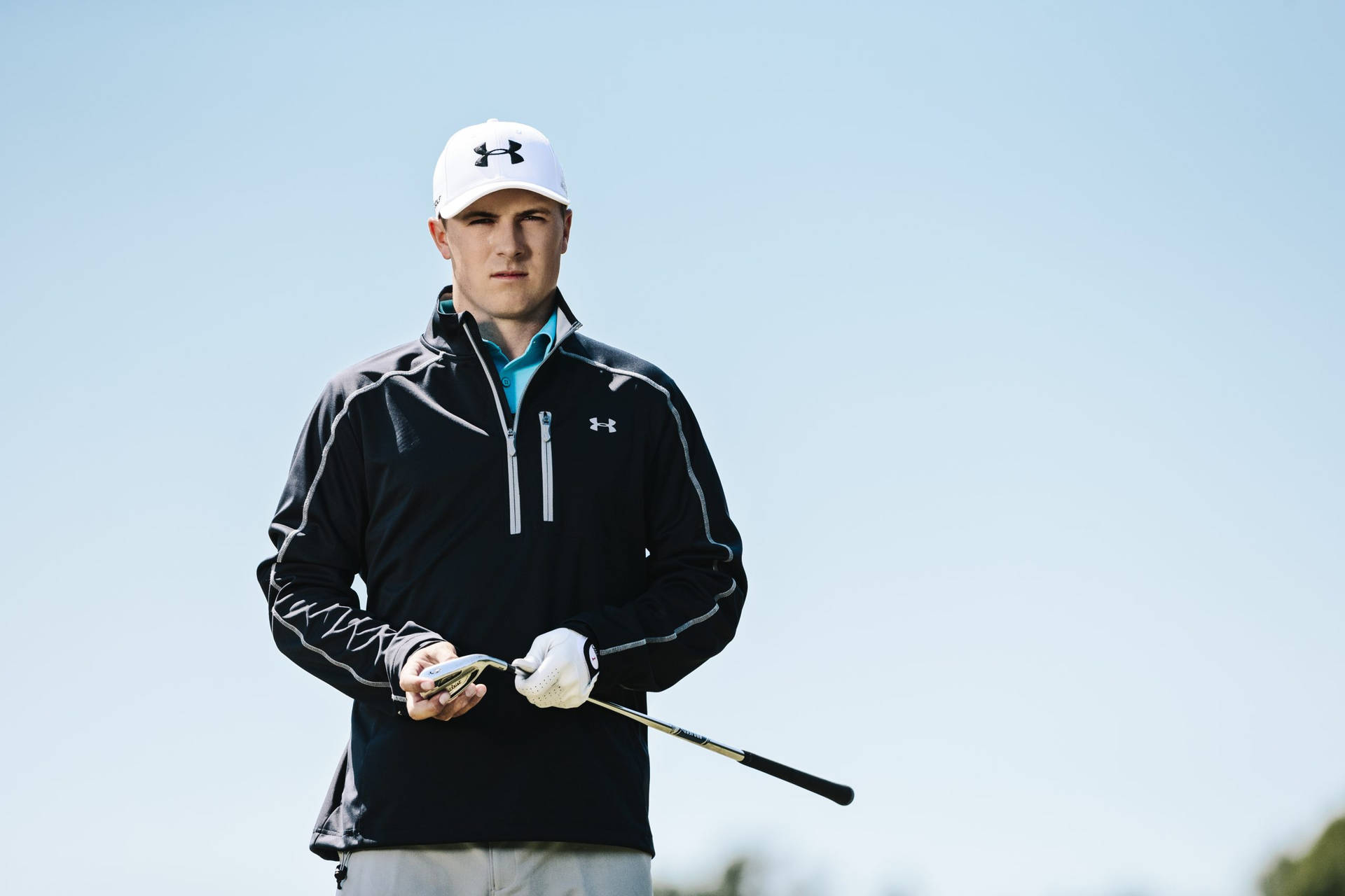 Squinting Jordan Spieth In Black Jacket Background