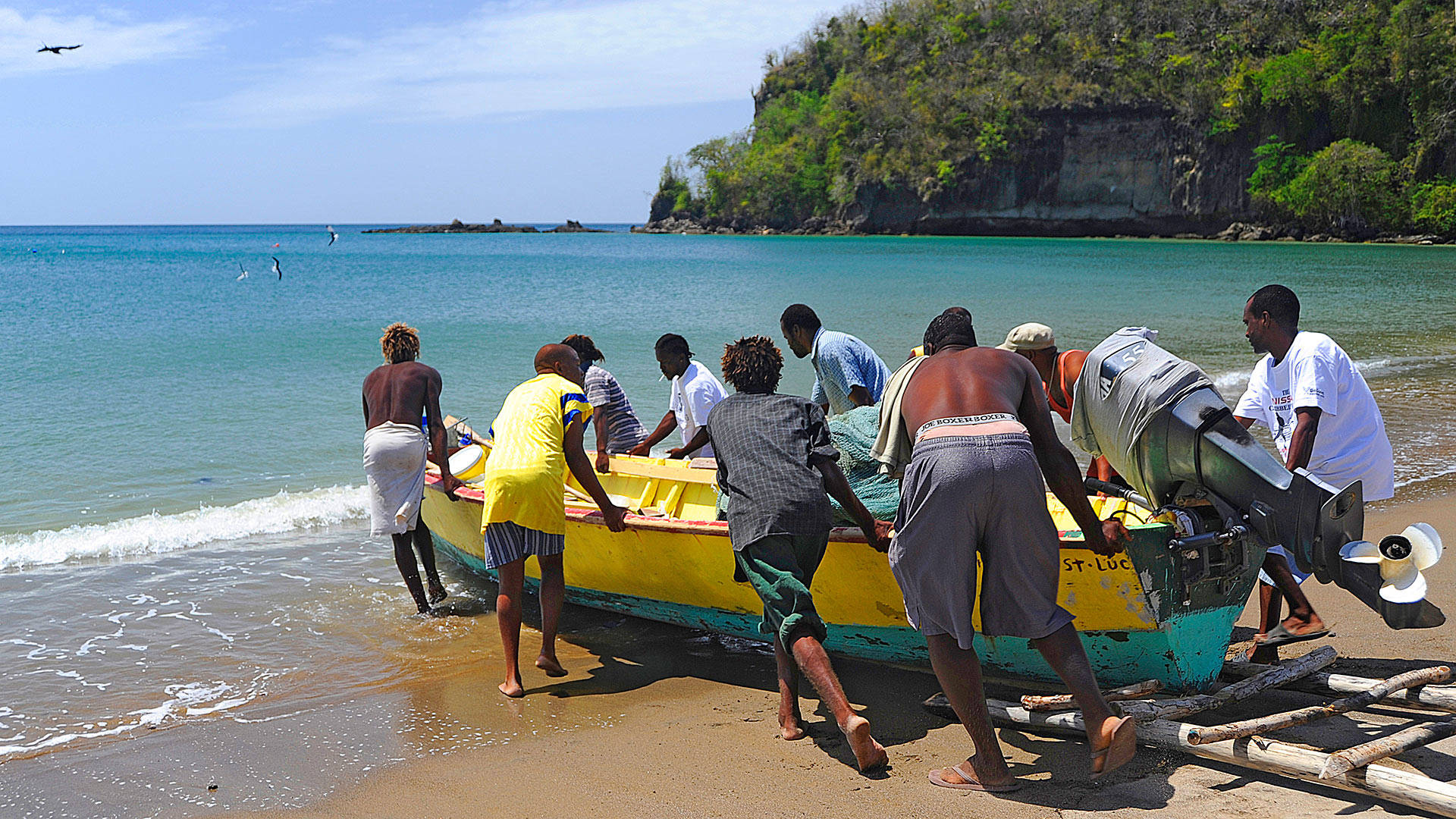 St. Lucia Men Pushing A Boat Background