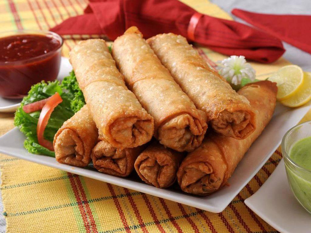 Stack Of Egg Rolls With Ketchup Dip Background