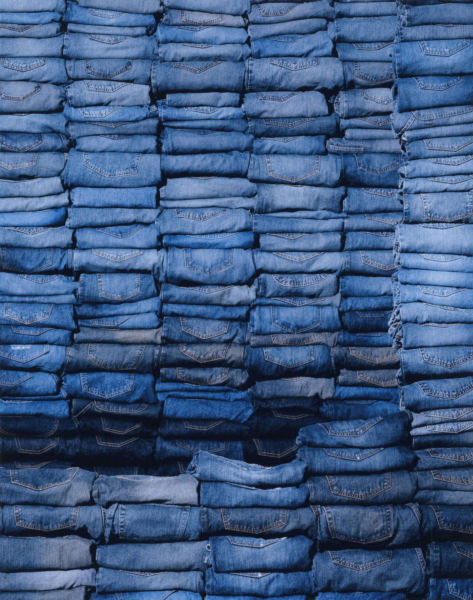 Stacks Of Denim Folded Jeans Background