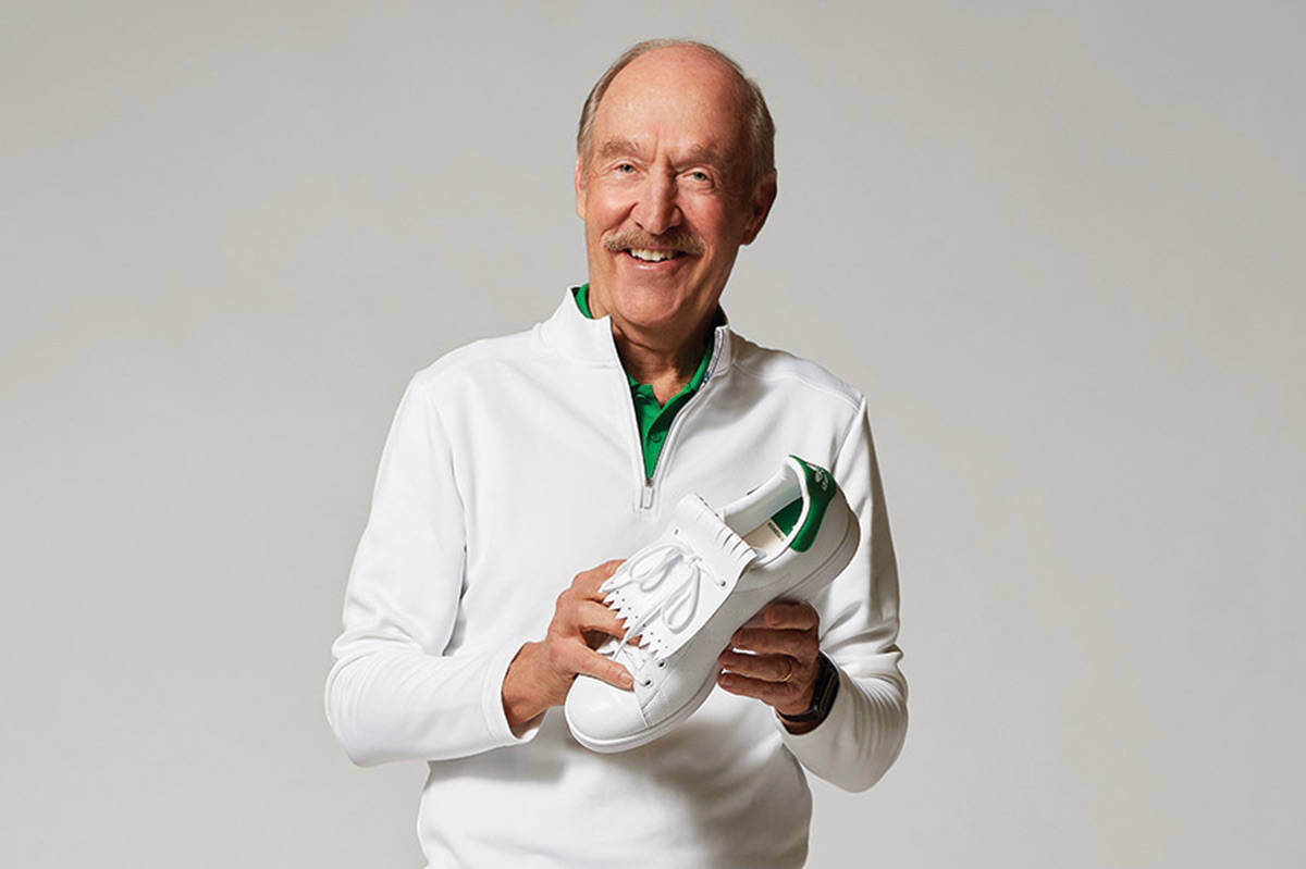 Stan Smith Wearing A White Long Sleeve Background