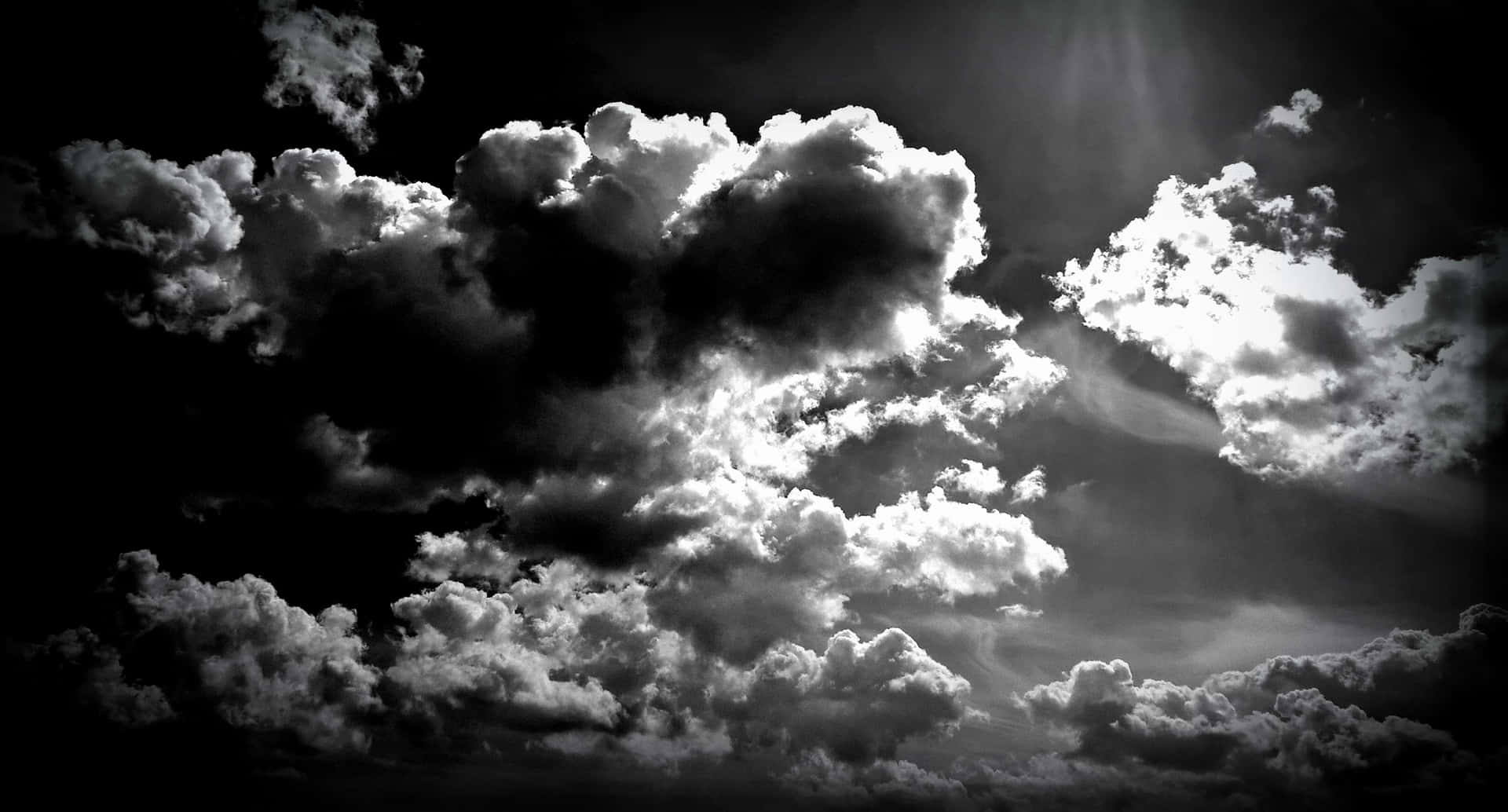 Standing Still And Being Challenged By The Mighty Black Clouds Background