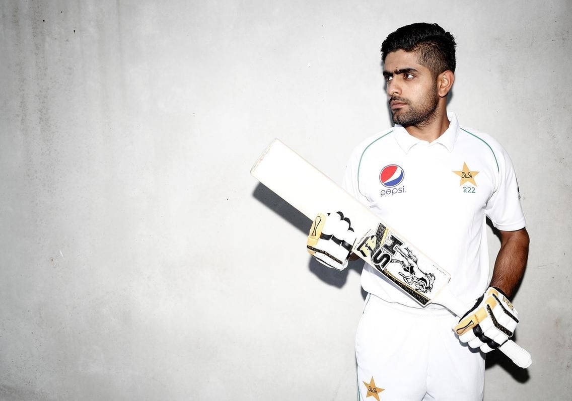 Star Cricketer Babar Azam In Action Background