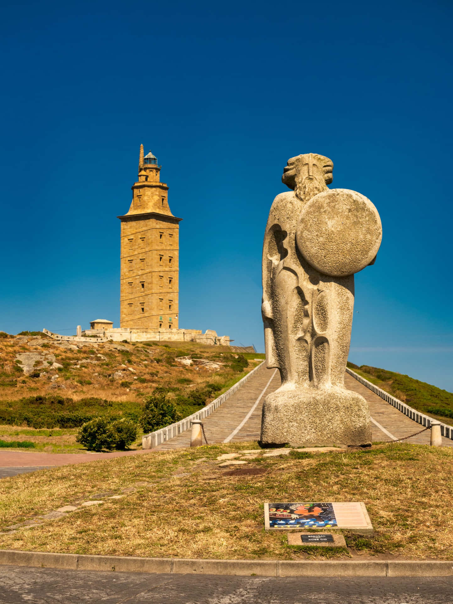 Statue Beside The Tower Of Hercules Background
