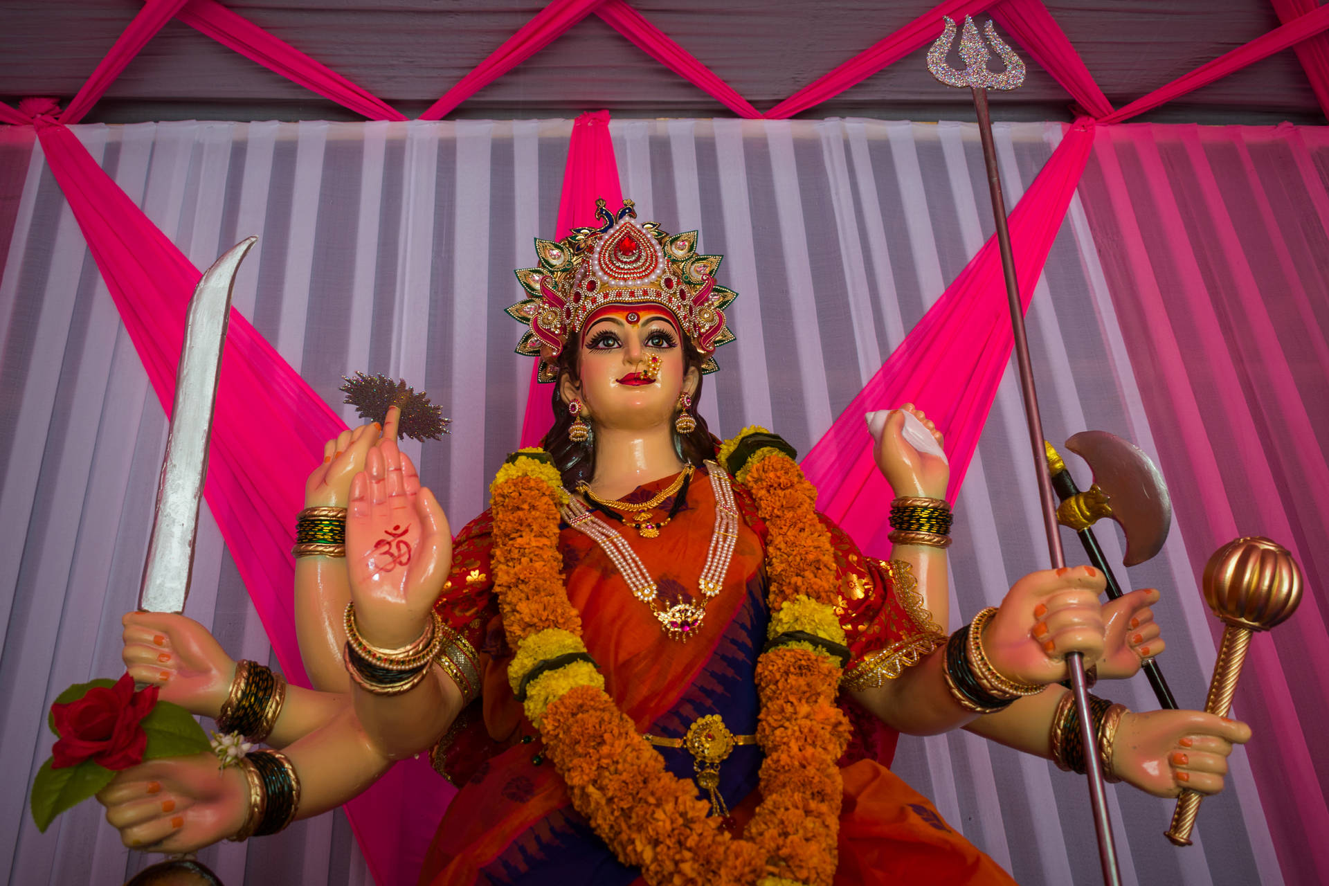 Statue Of Ambe Maa In Red Sari Background