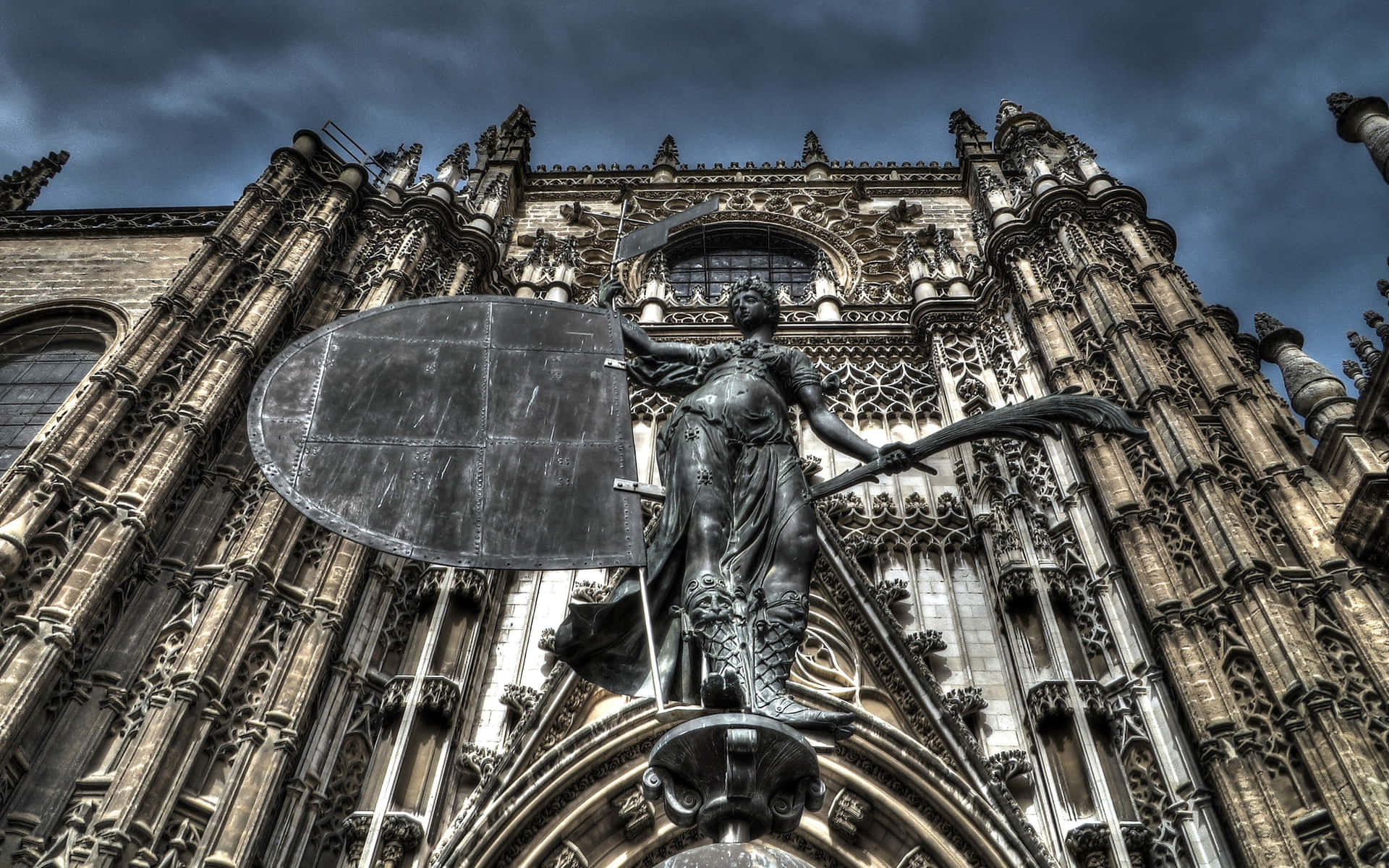 Statue Outside The Seville Cathedral Background