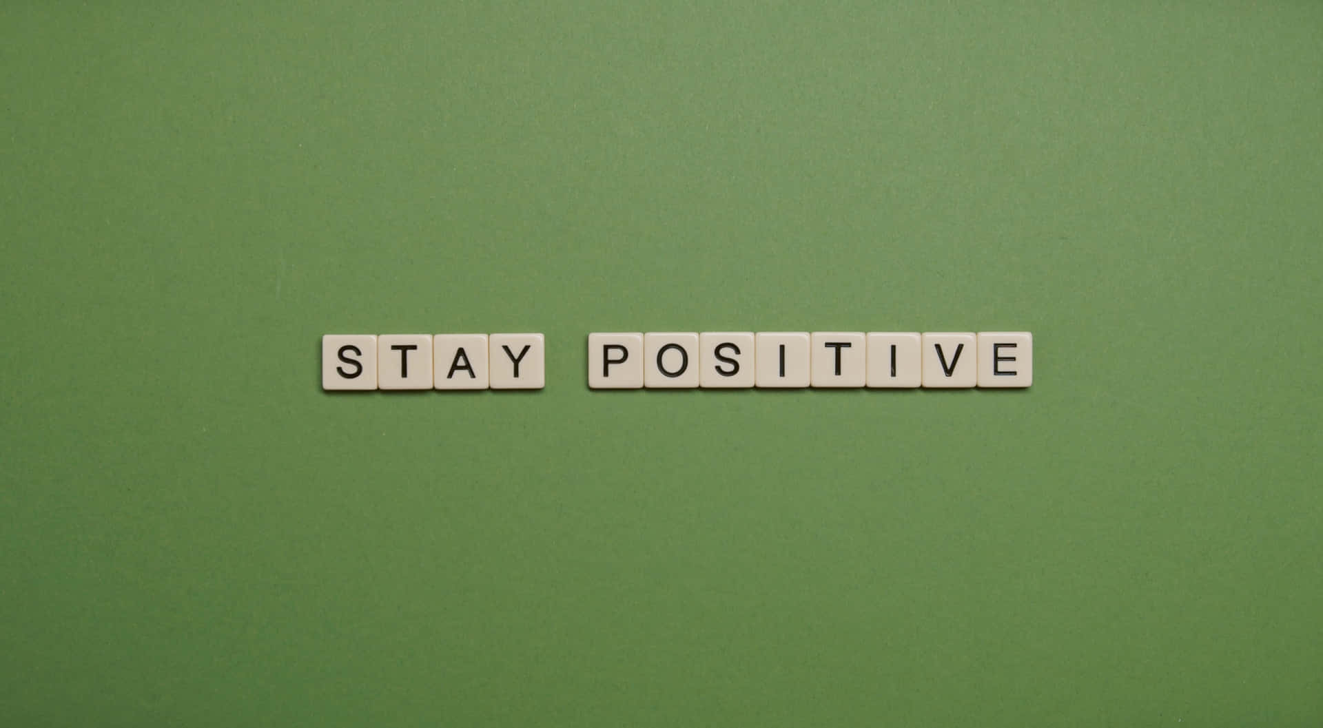 Stay Positive Scrabble Word On Green Background