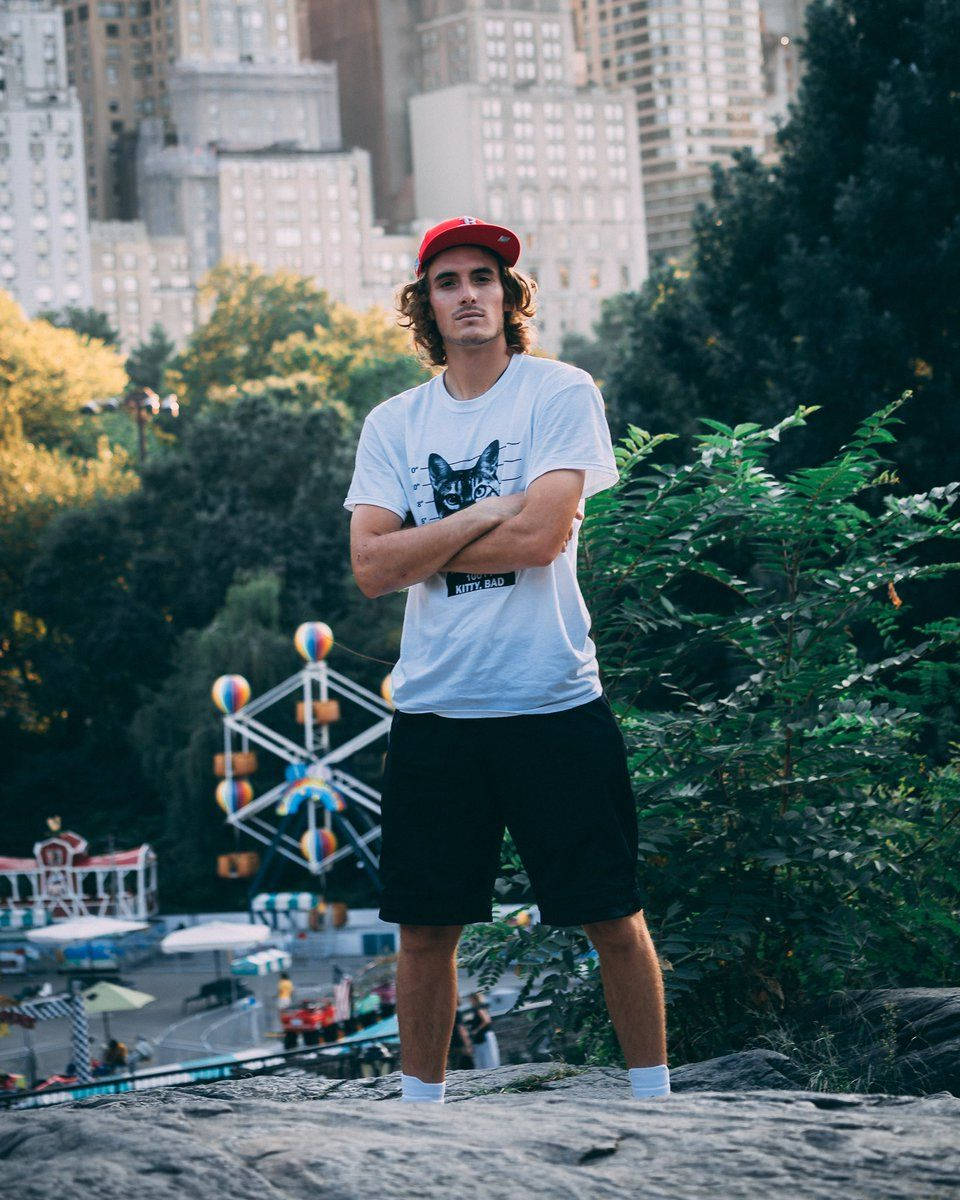 Stefanos Tsitsipas At An Amusment Park Background