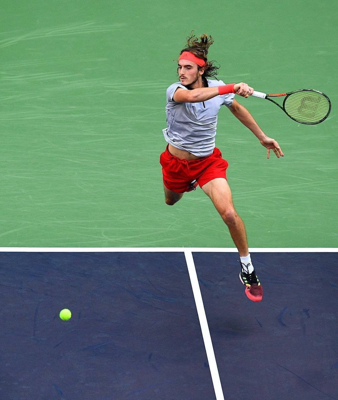 Stefanos Tsitsipas Jumping Midair Background