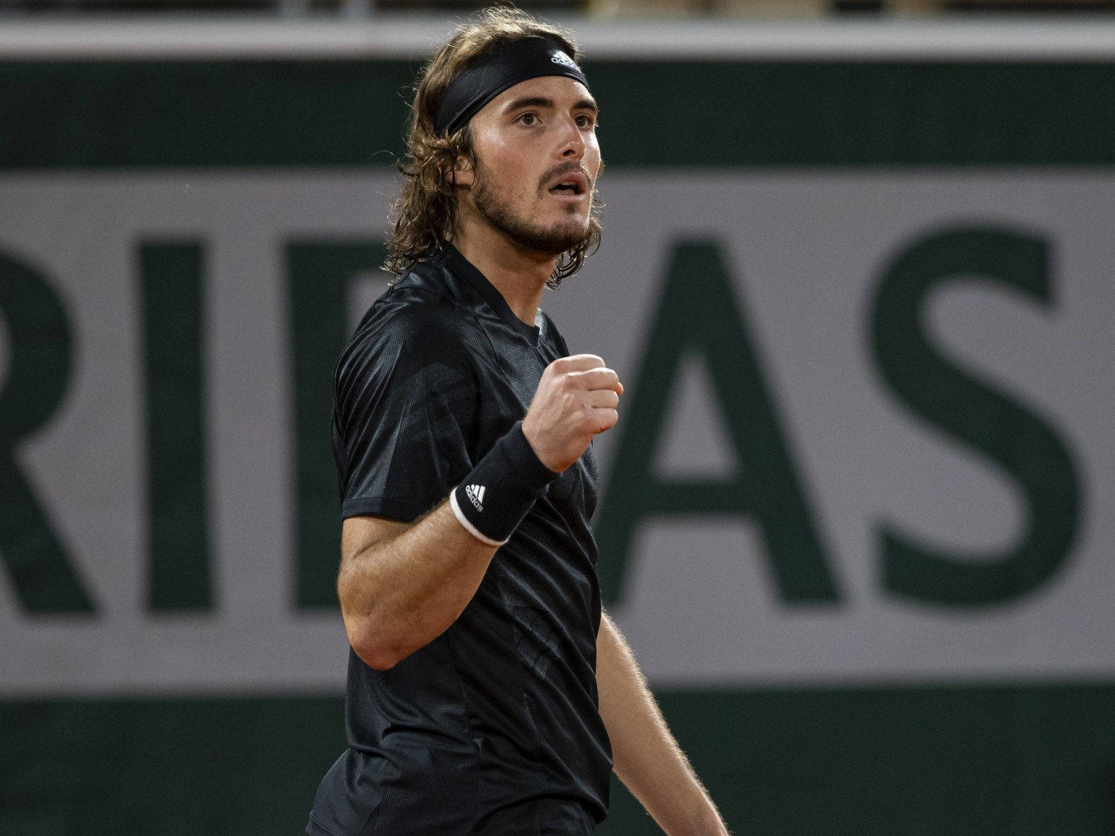 Stefanos Tsitsipas Looking Up Background