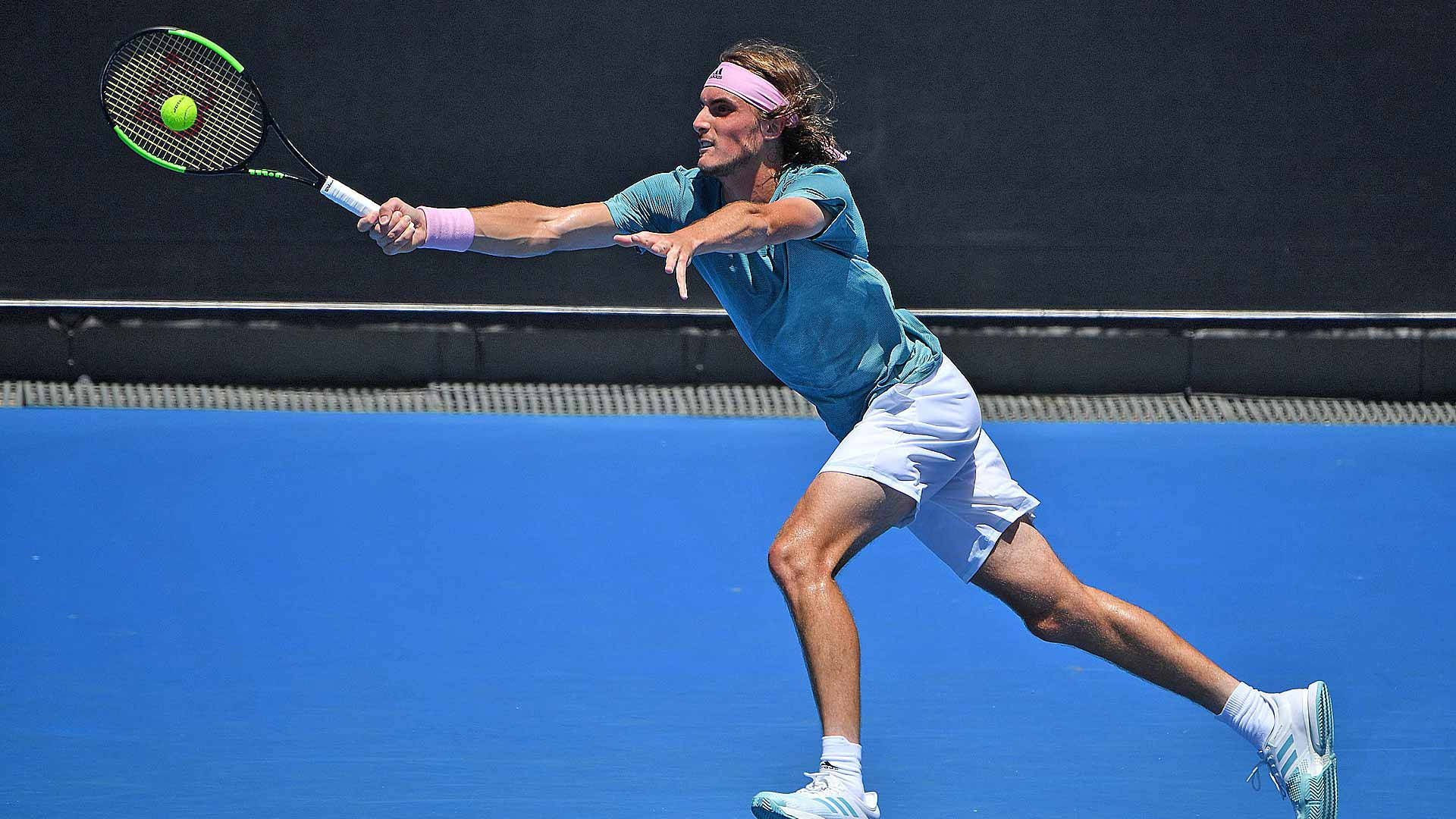 Stefanos Tsitsipas Reaching For Tennis Ball Background