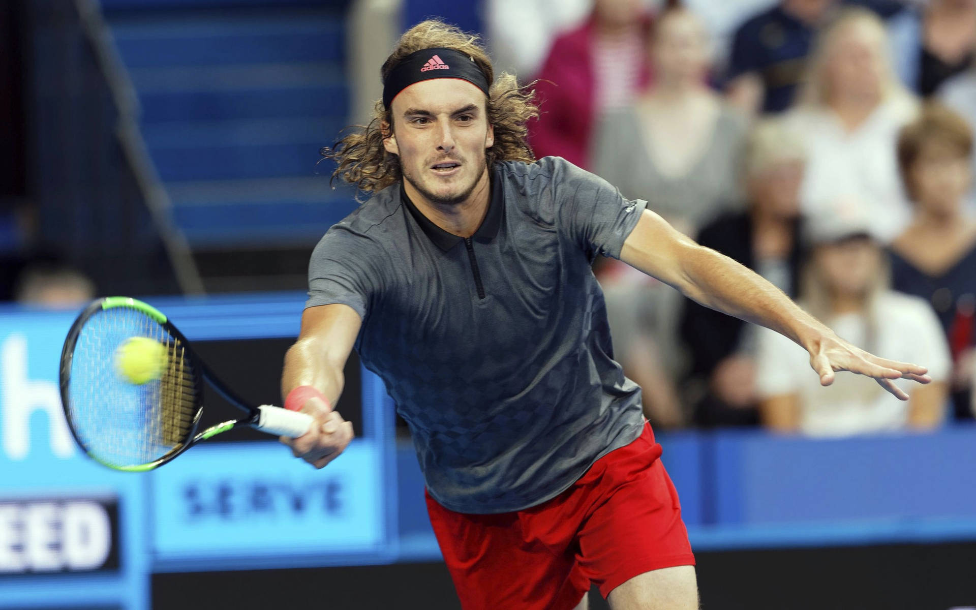 Stefanos Tsitsipas Running After Tennis Ball Background