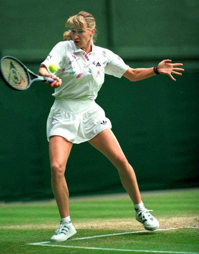 Steffi Graf Hitting A Ball Background