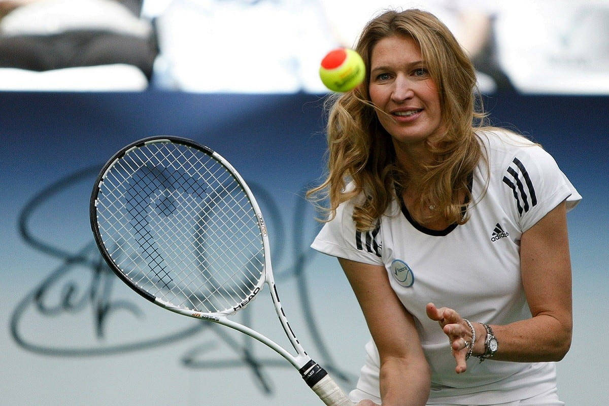 Steffi Graf Poised With A Tennis Ball Background