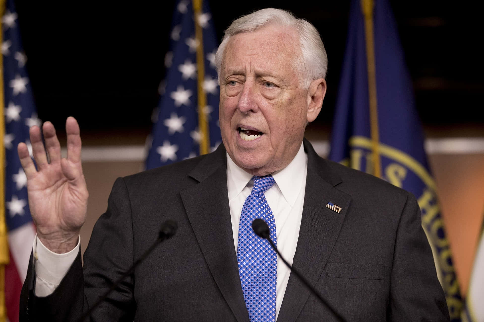 Steny Hoyer Passionately Raising His Hand While Delivering A Powerful Speech. Background