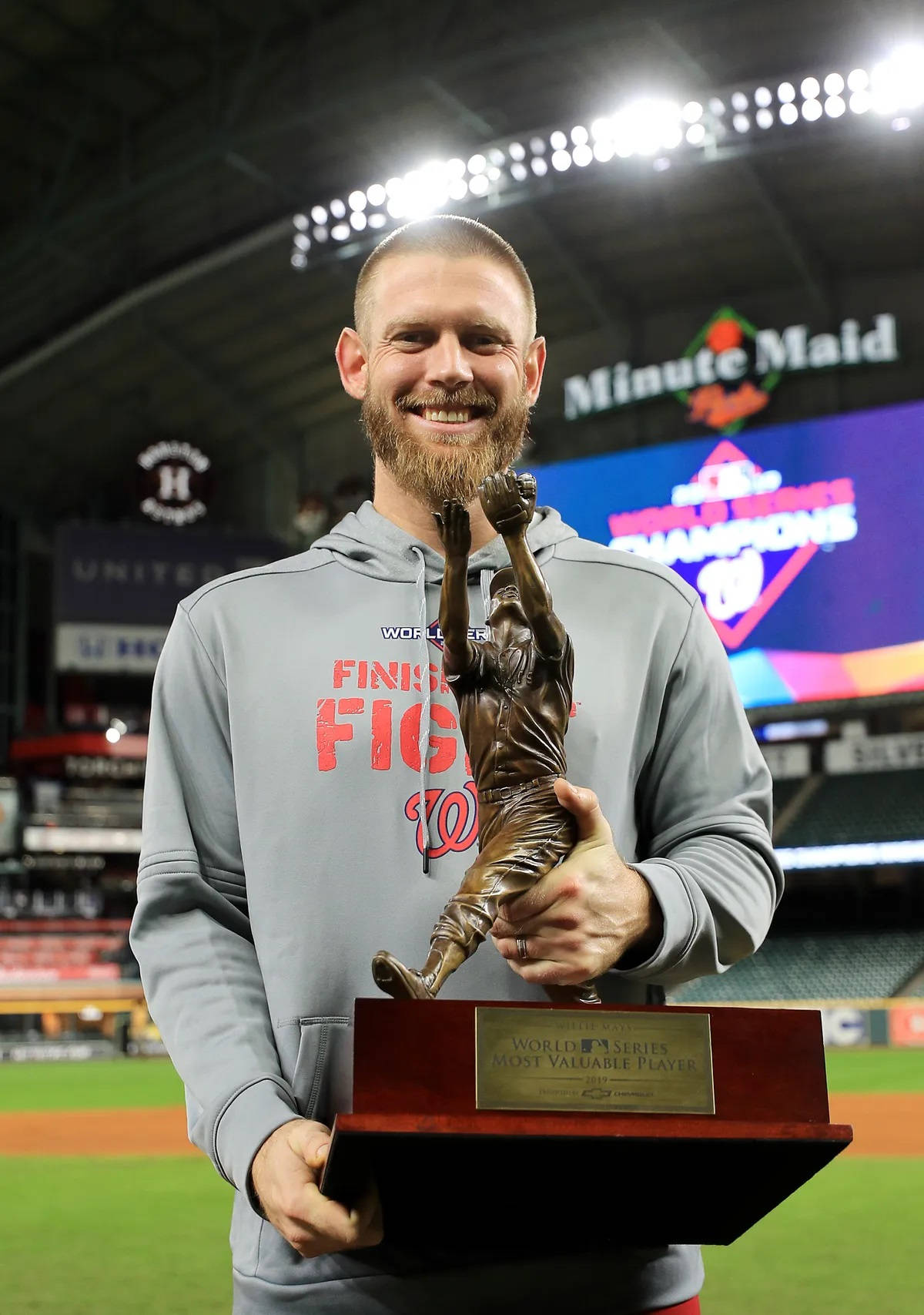 Stephen Strasburg Holding His Mvp Trophy Smiling Background