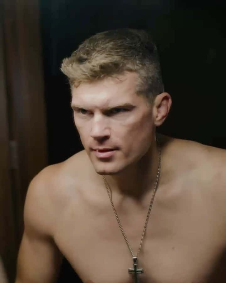 Stephen Thompson Delivering A Powerful Kick During A Martial Arts Competition