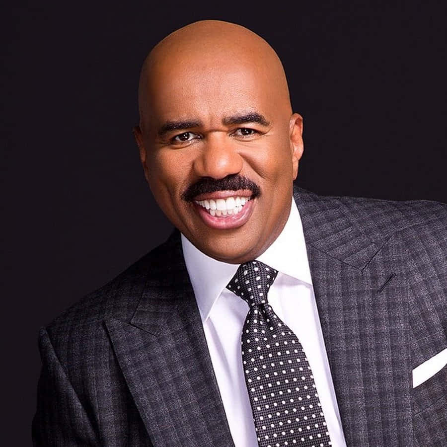 Steve Harvey Dazzles In A Checkered Suit Background