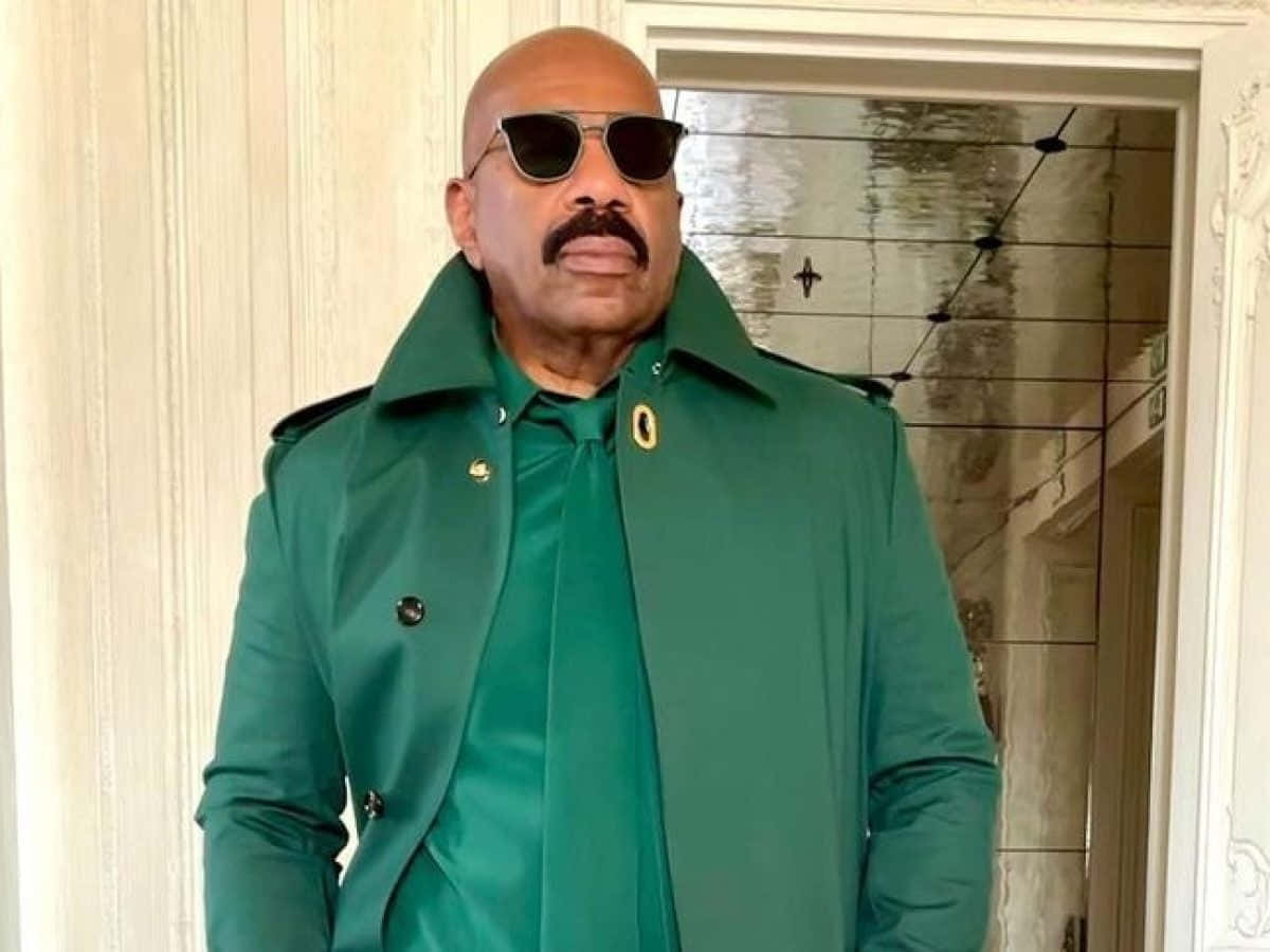 Steve Harvey In A Green Outfit With Sunglasses Background