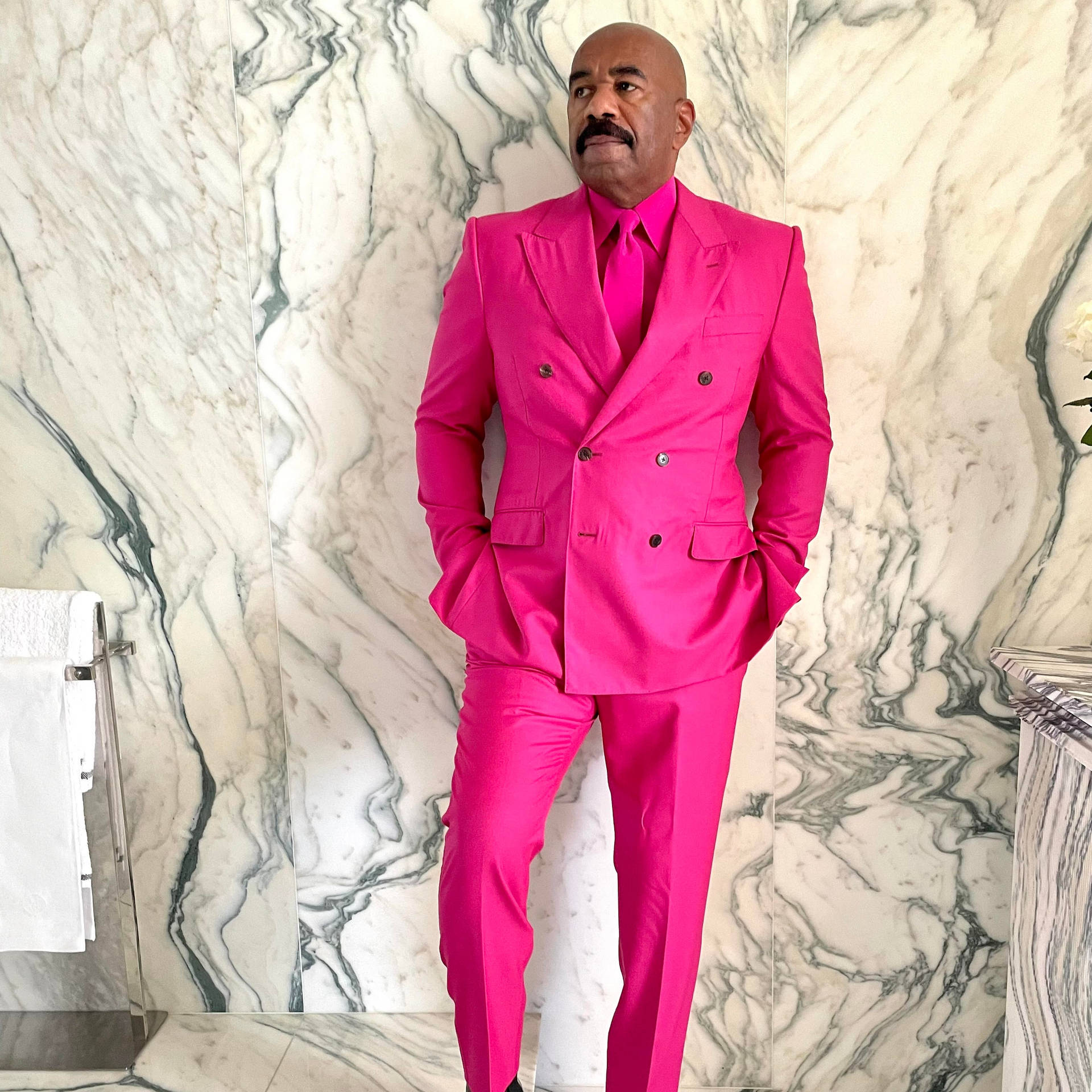 Steve Harvey Vibrantly Stands Out In A Hot Pink Suit Background