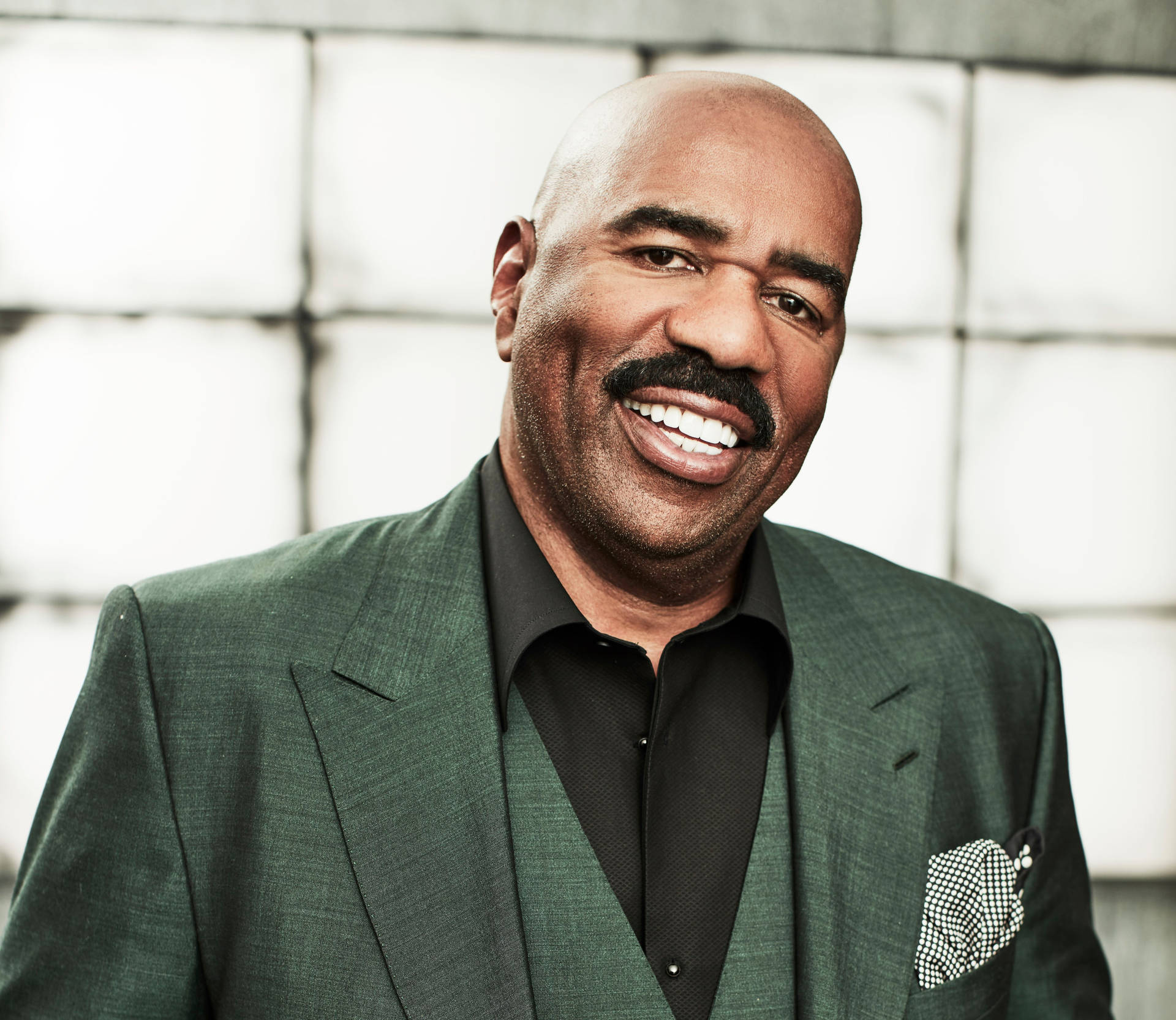 Steve Harvey With Black And Green Suit Background