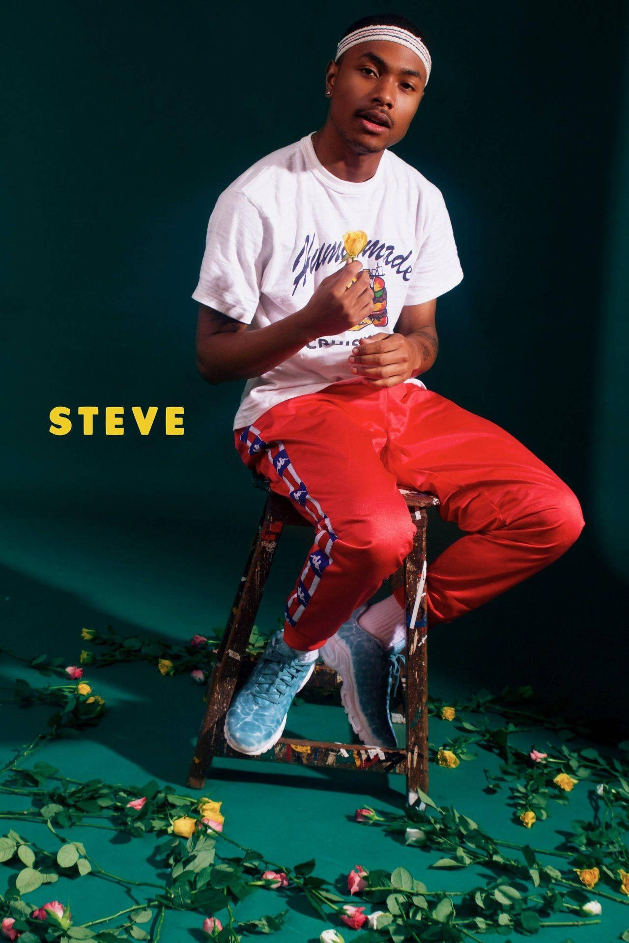 Steve Lacy Sportwear Sitting On Stool Background