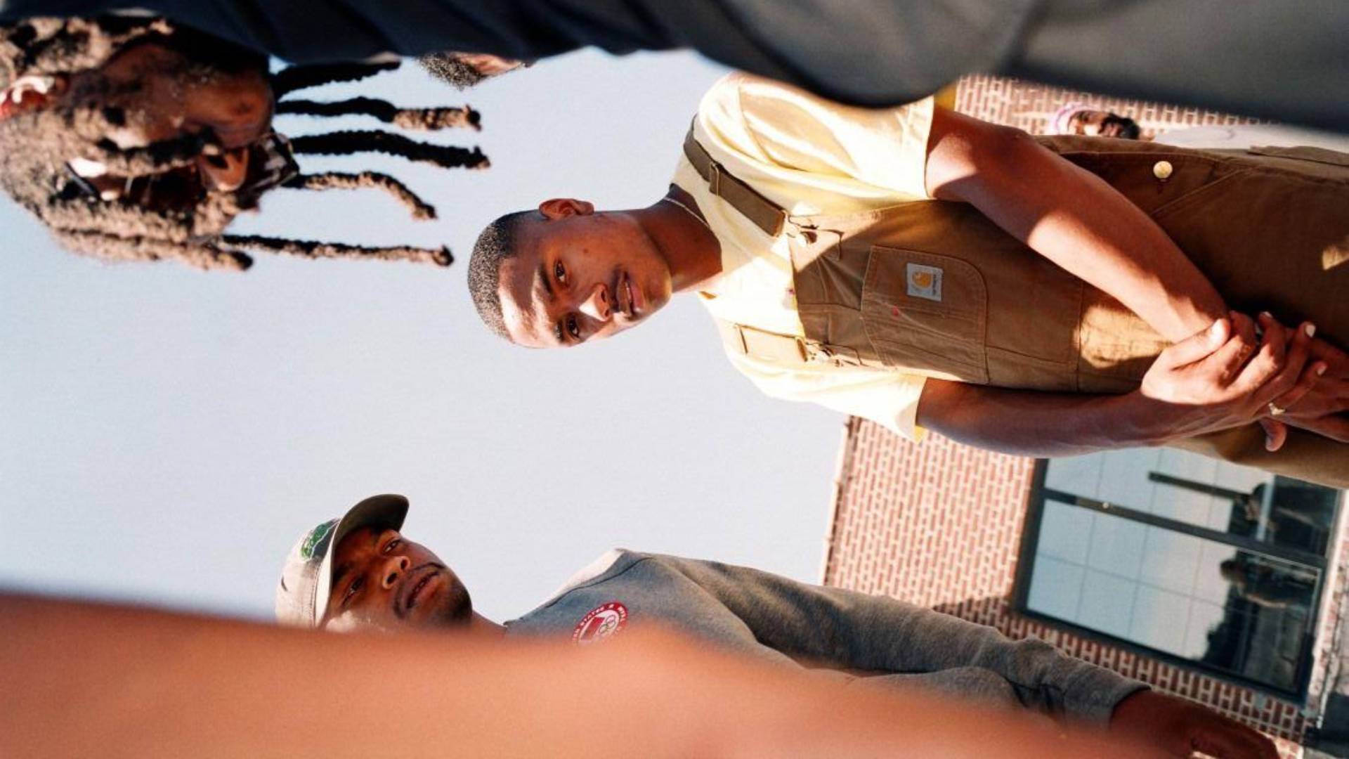 Steve Lacy Wearing Brown Overalls Background