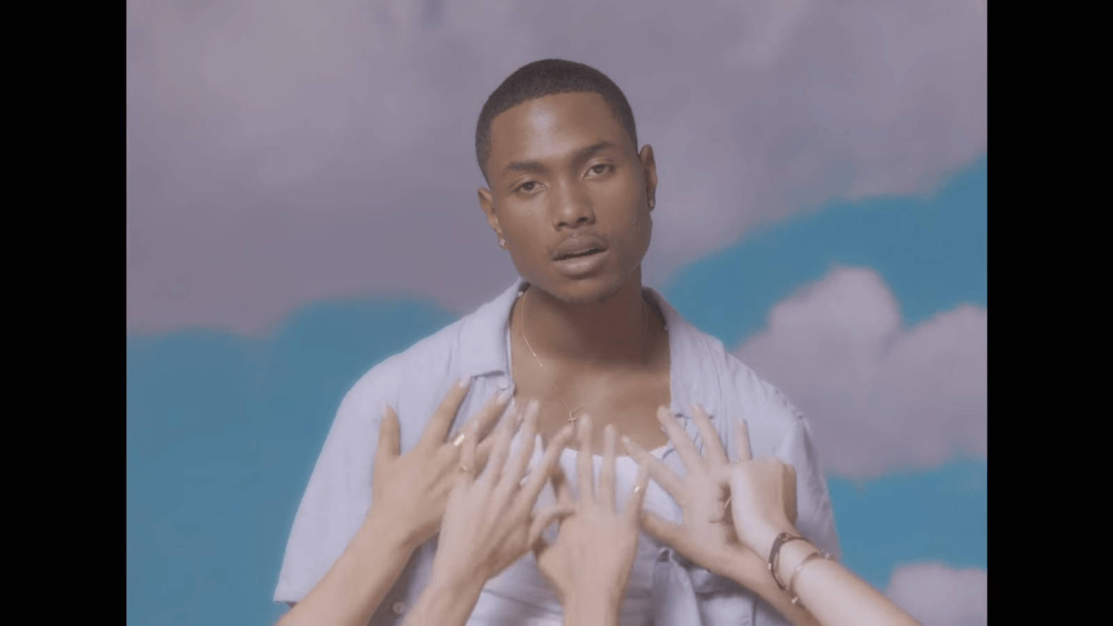 Steve Lacy With Hands Reaching For His Chest Background