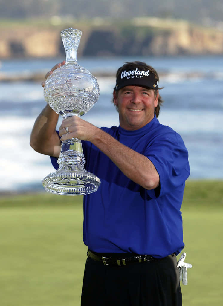 Steve Lowery Proudly Holding Up Trophy Background