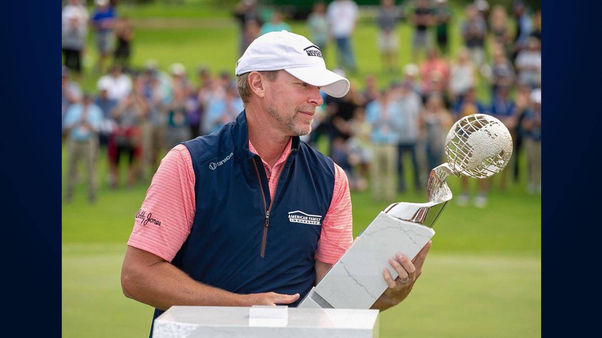 Steve Stricker Admiring A Trophy Background