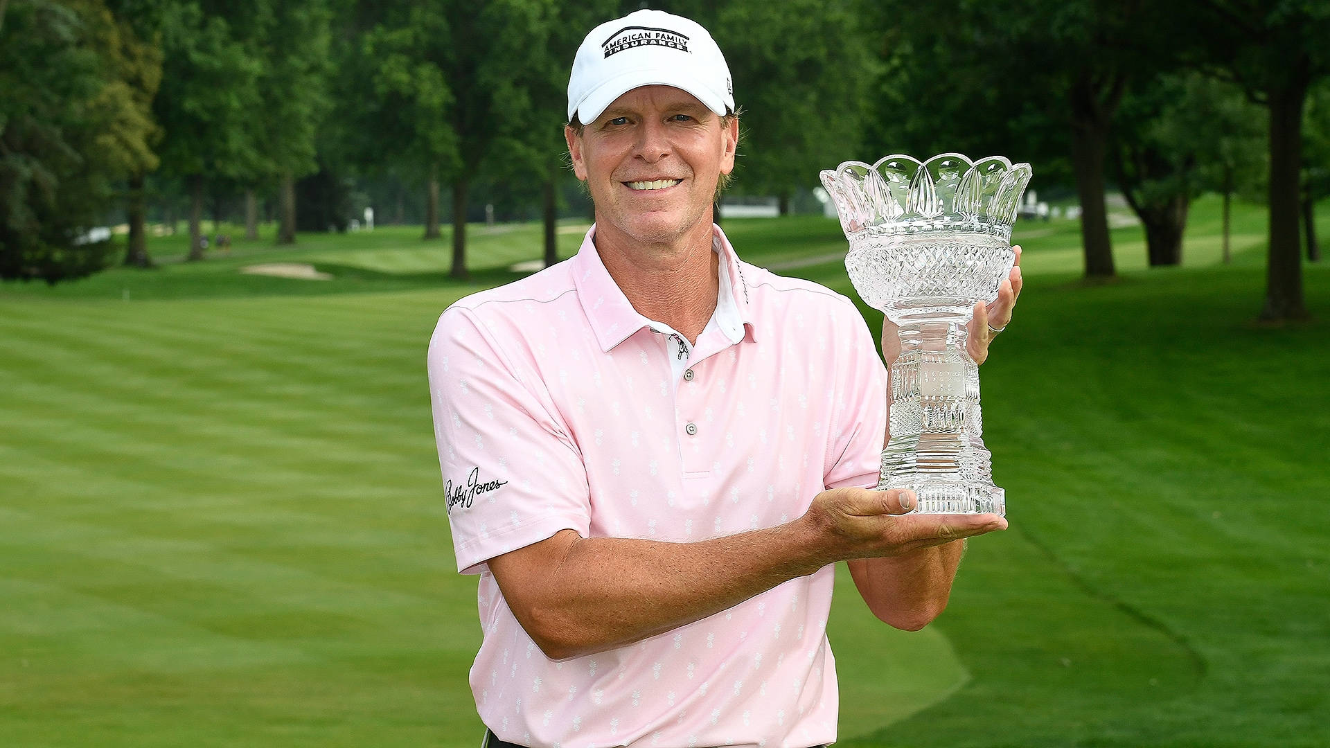 Steve Stricker Holding A Trophy Background