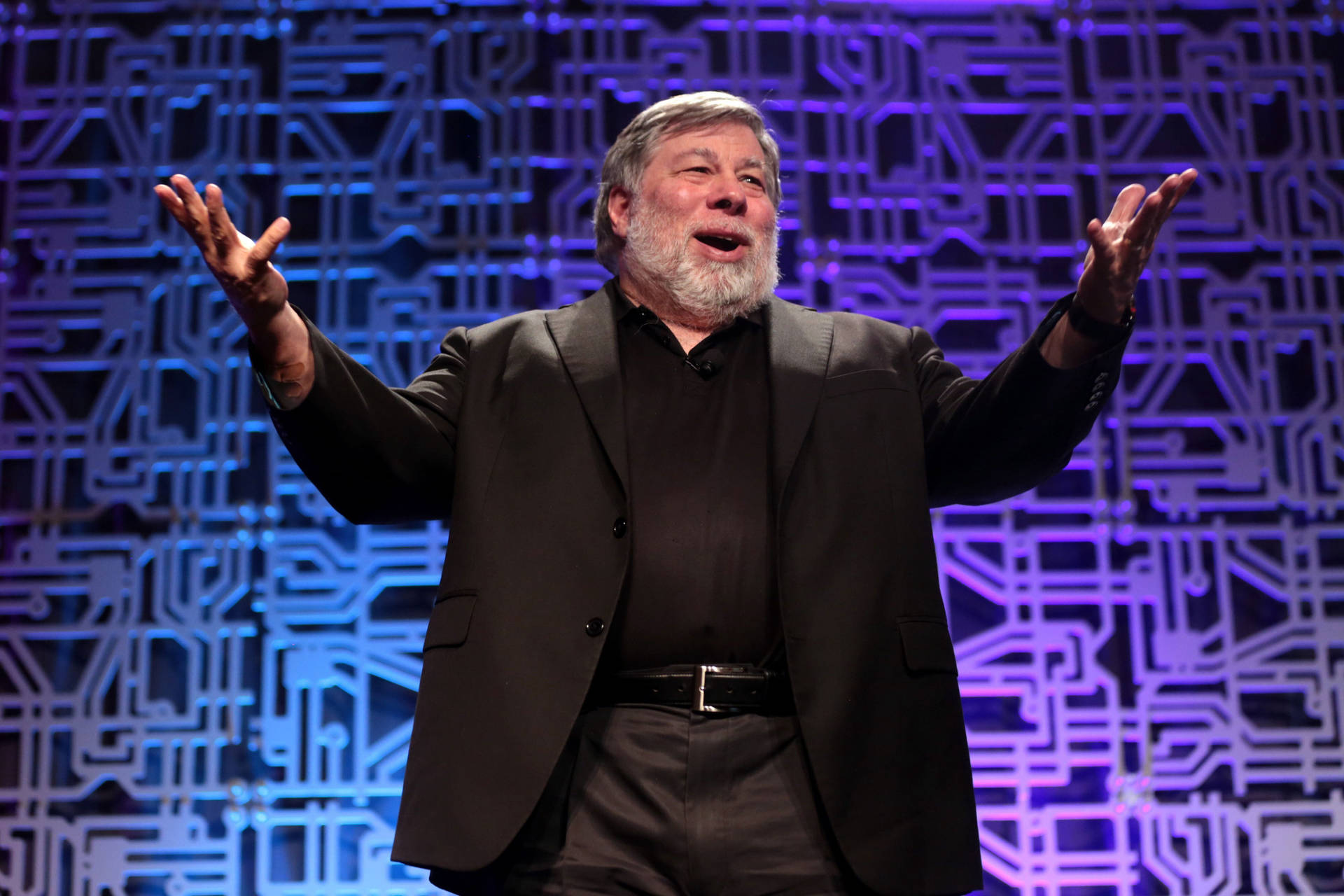 Steve Wozniak Raising Both Hands While Standing Background