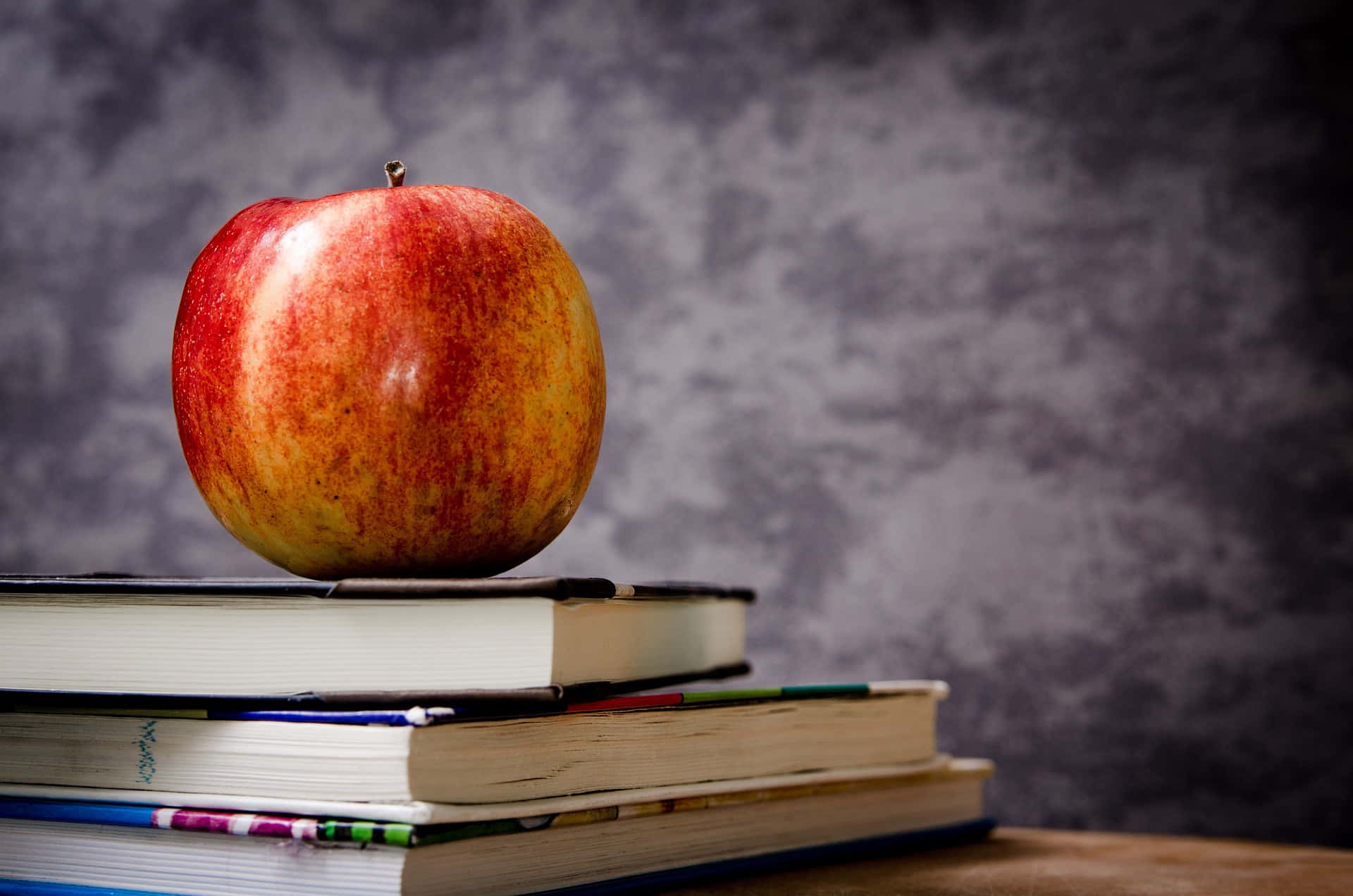 Still Apple On Top Of Books Background
