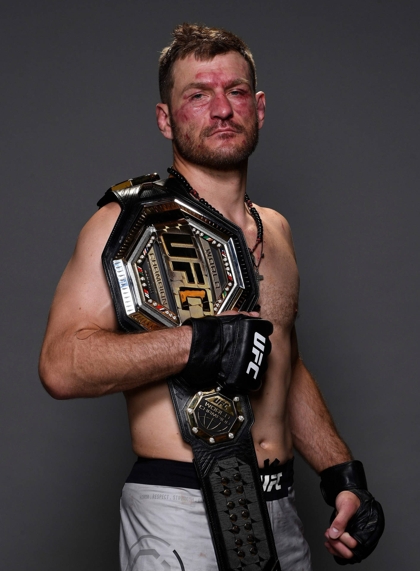 Stipe Miocic - Bloodied Yet Victorious, Showcasing His Championship Belt