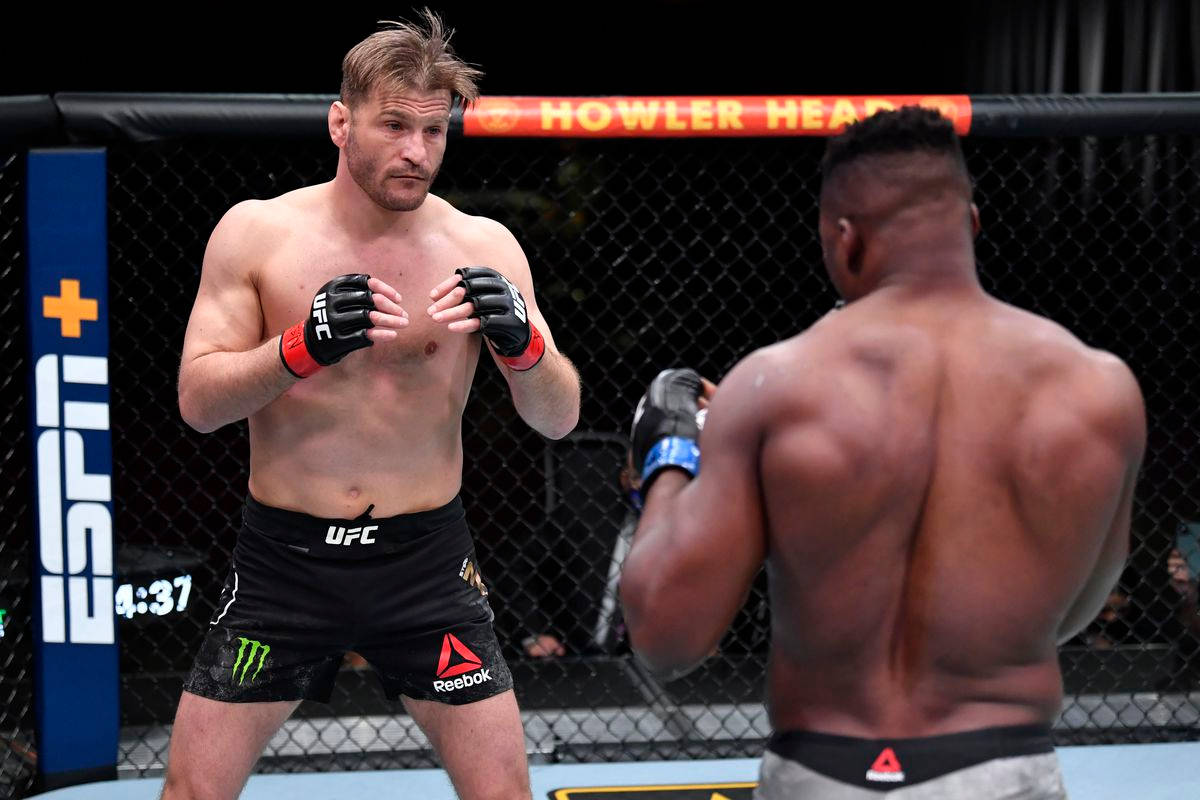 Stipe Miocic Poised In The Fighting Ring Background