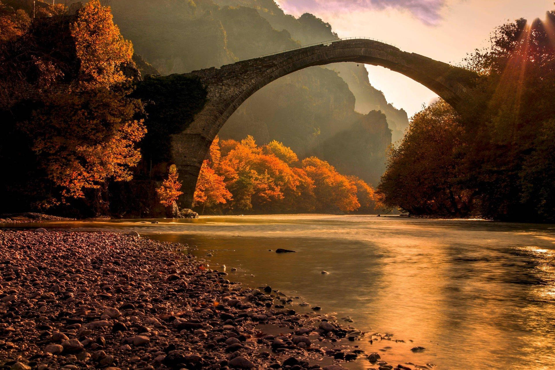 Stone Bridge Connected To The Riverside