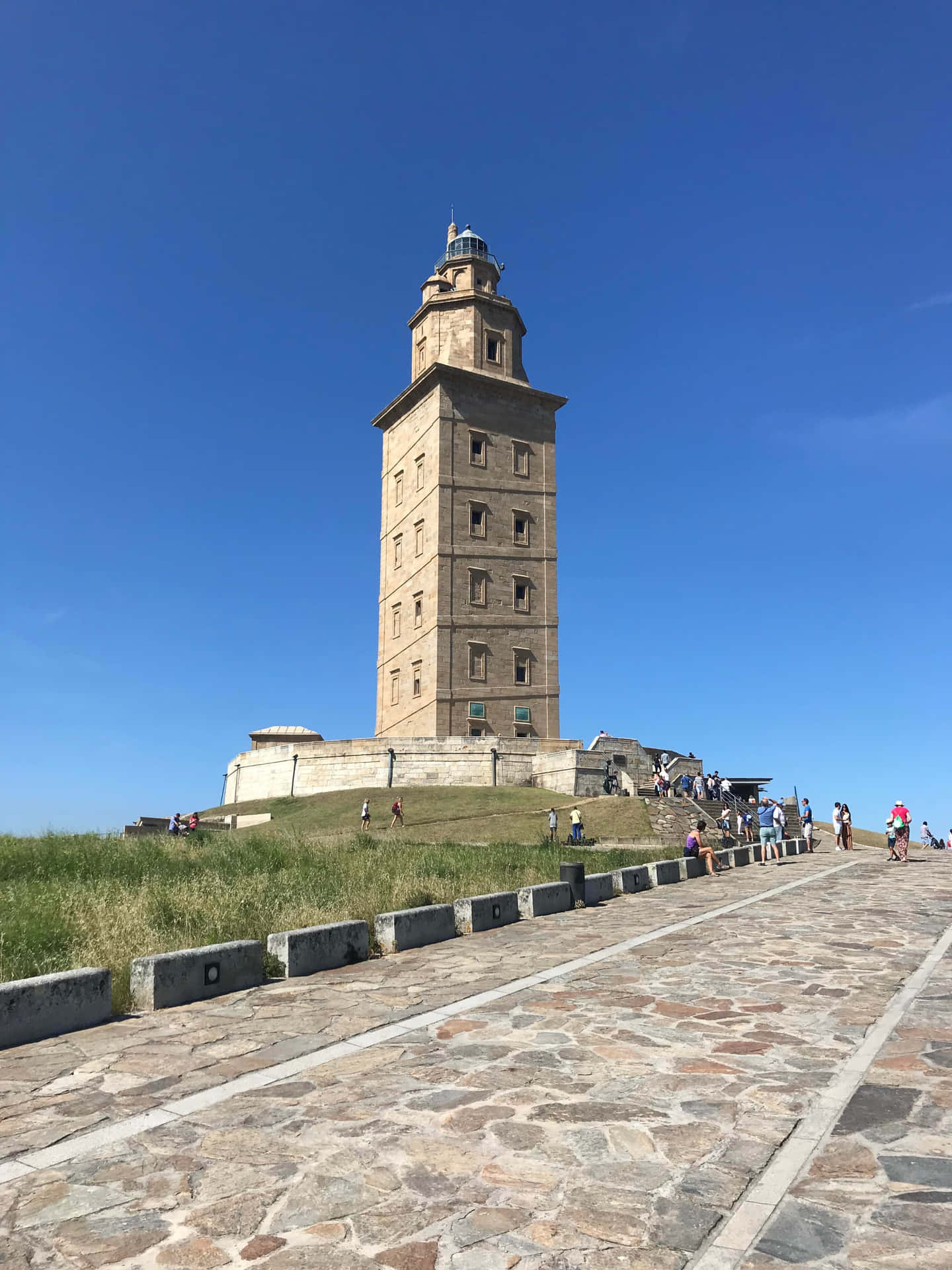 Stone Pathway Along The Tower Of Hercules Phone Background