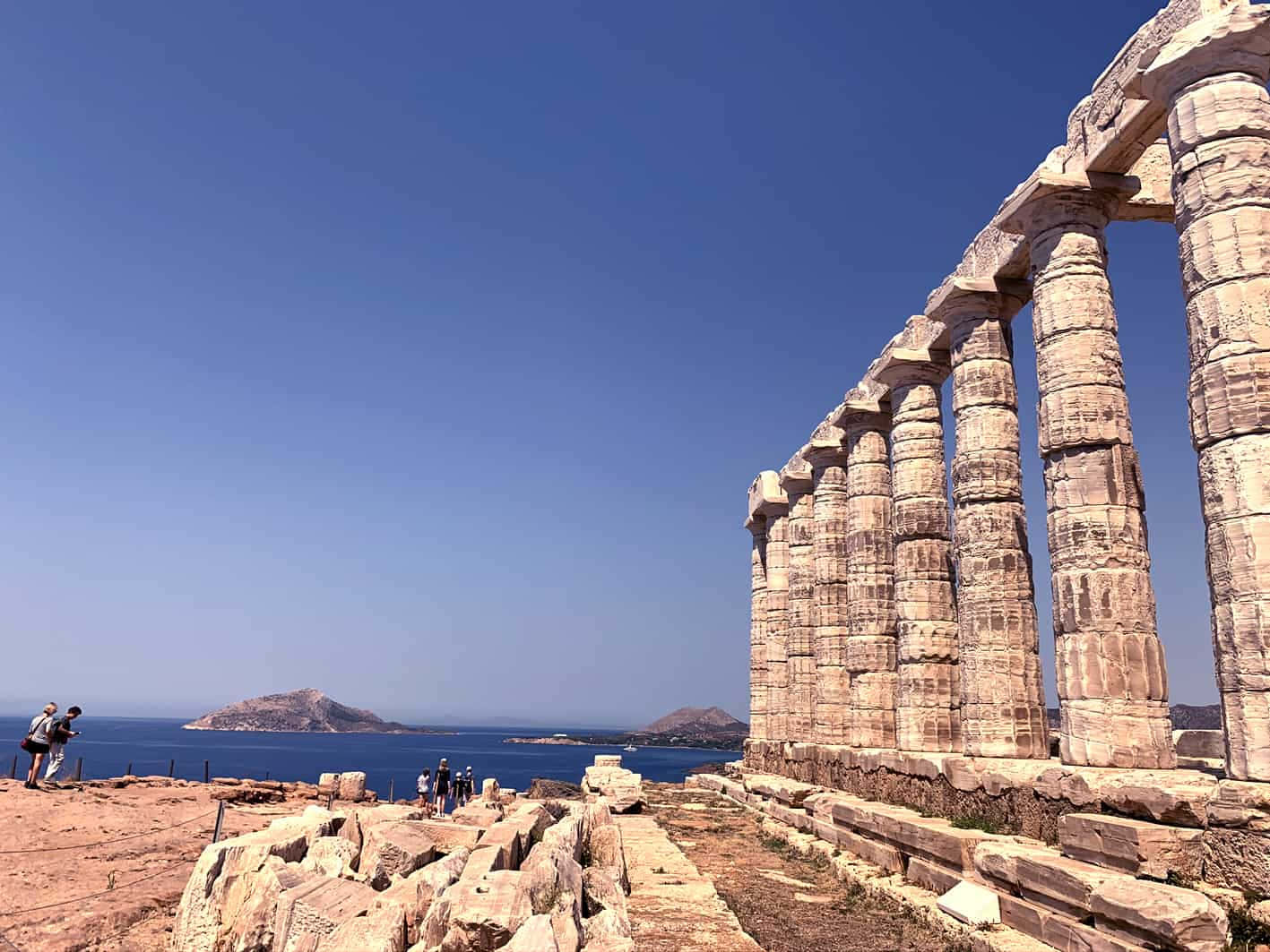 Stone Pillars Beneath Sky Sounion Background