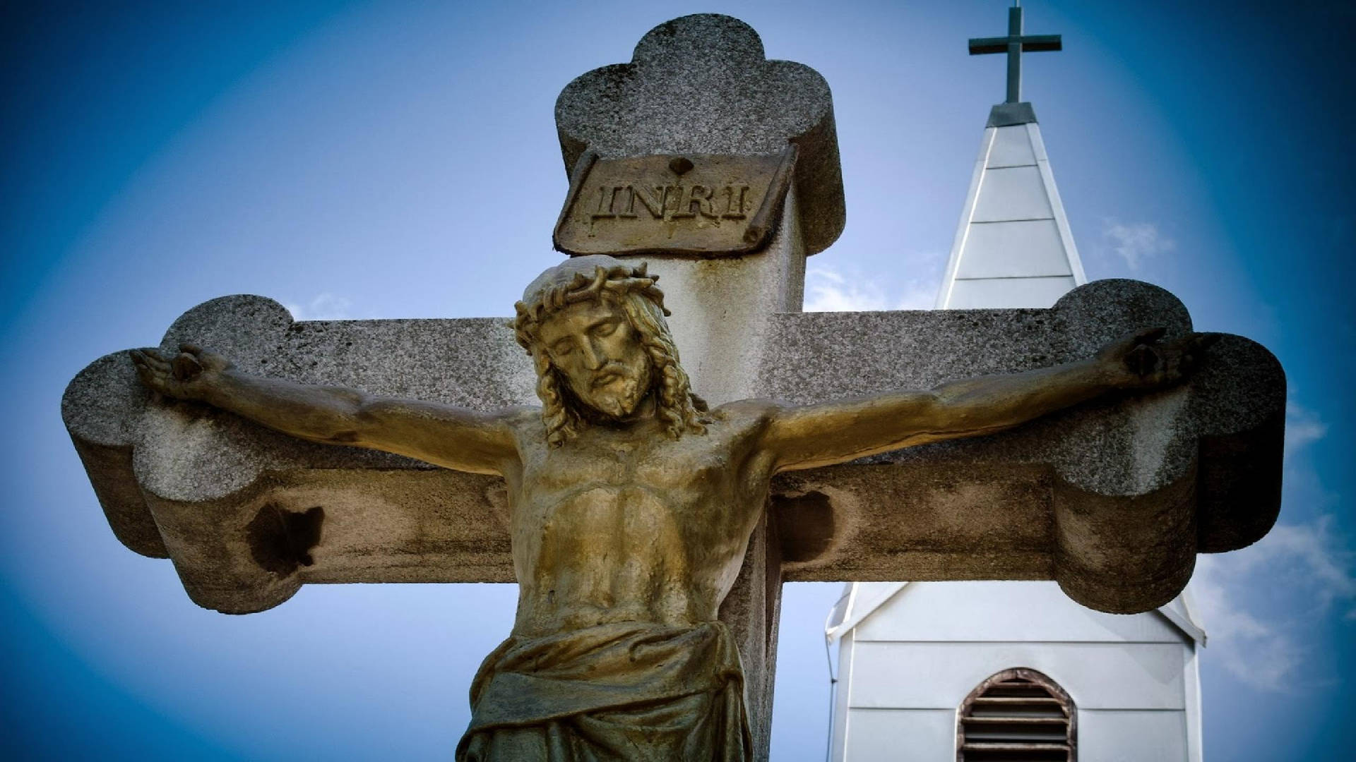 Stone Sculpture Of Jesus On Cross Background