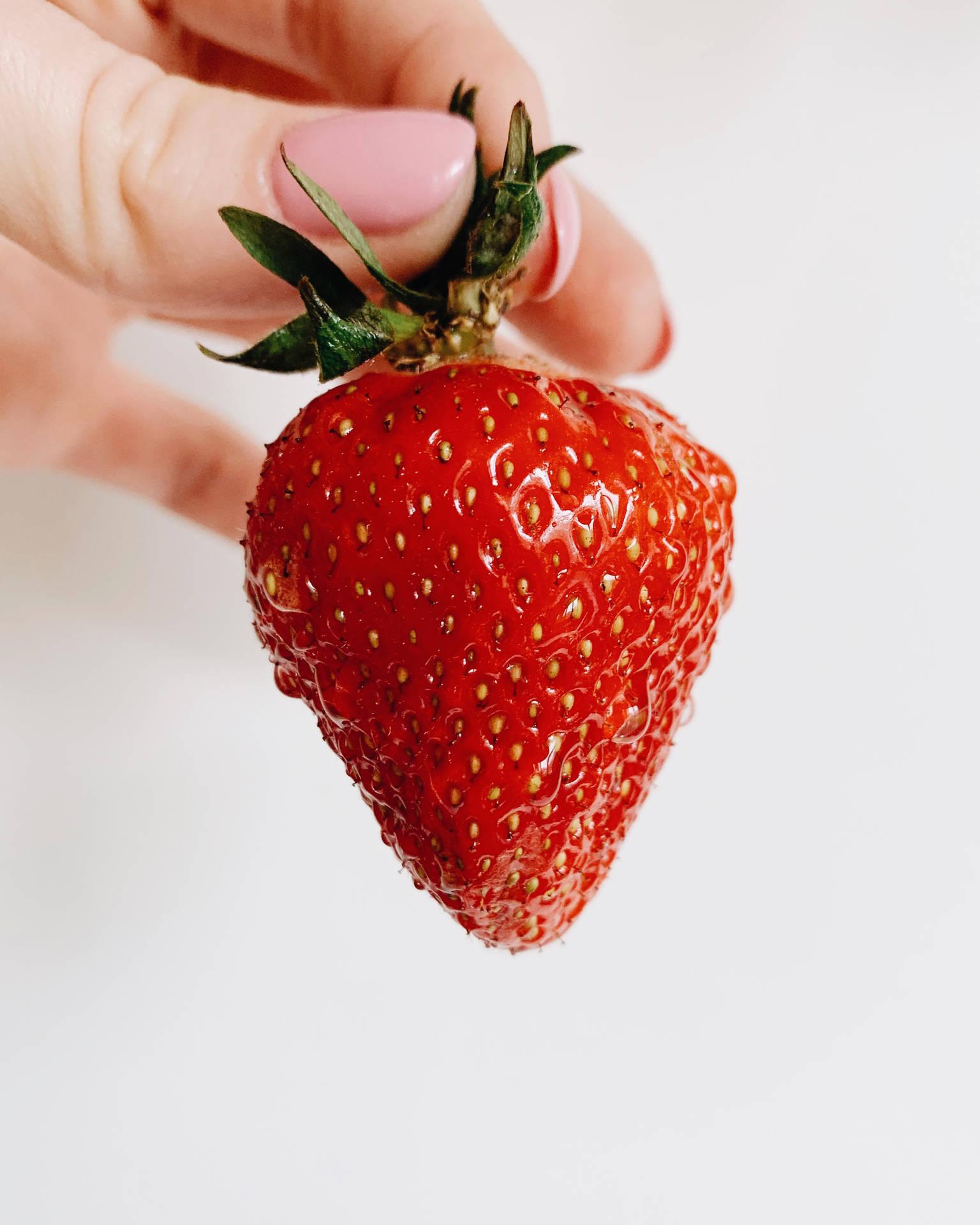 Strawberry Fruit Held By Hand Background