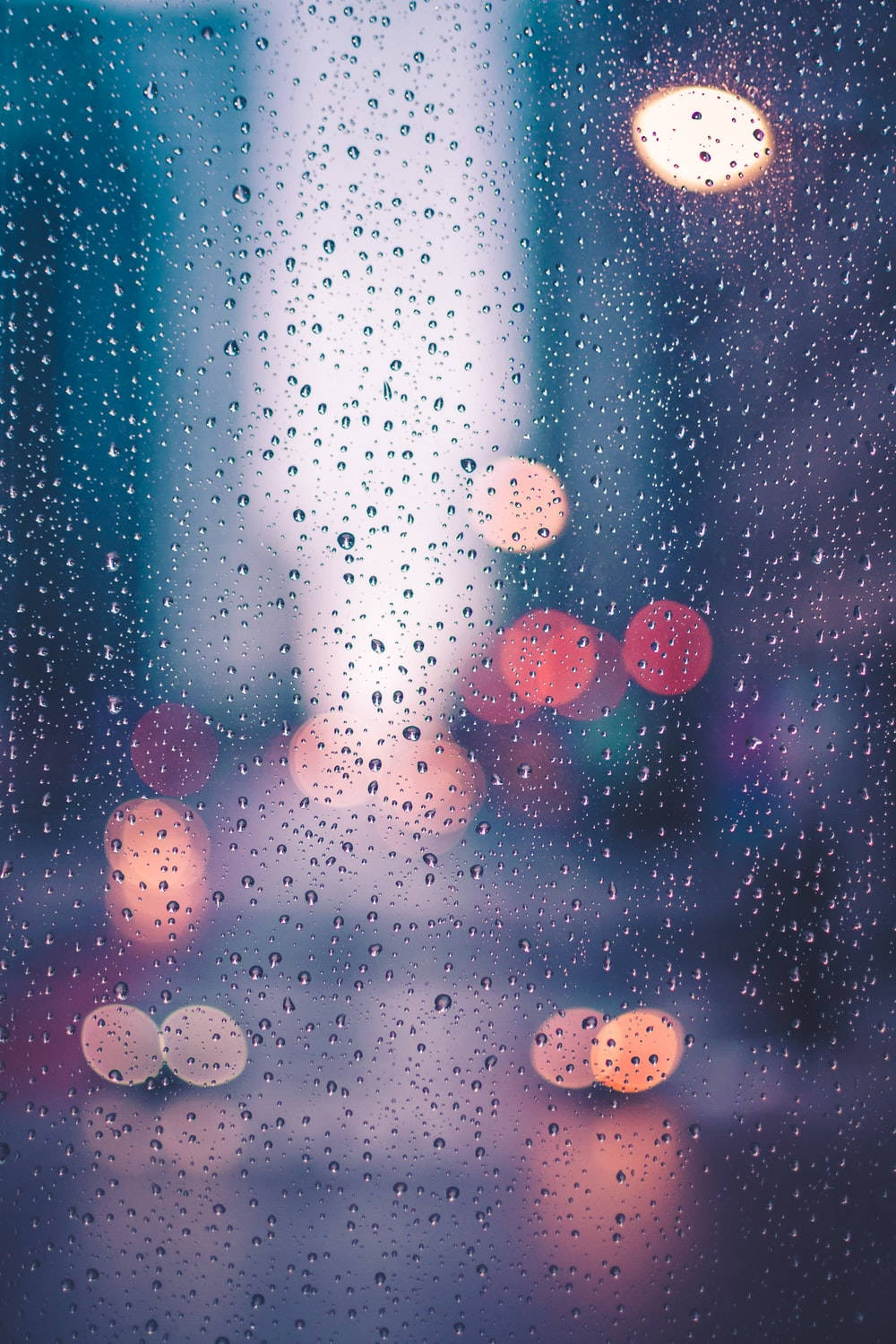 Street Lights Gleaming Through Sparkling Raindrops Background