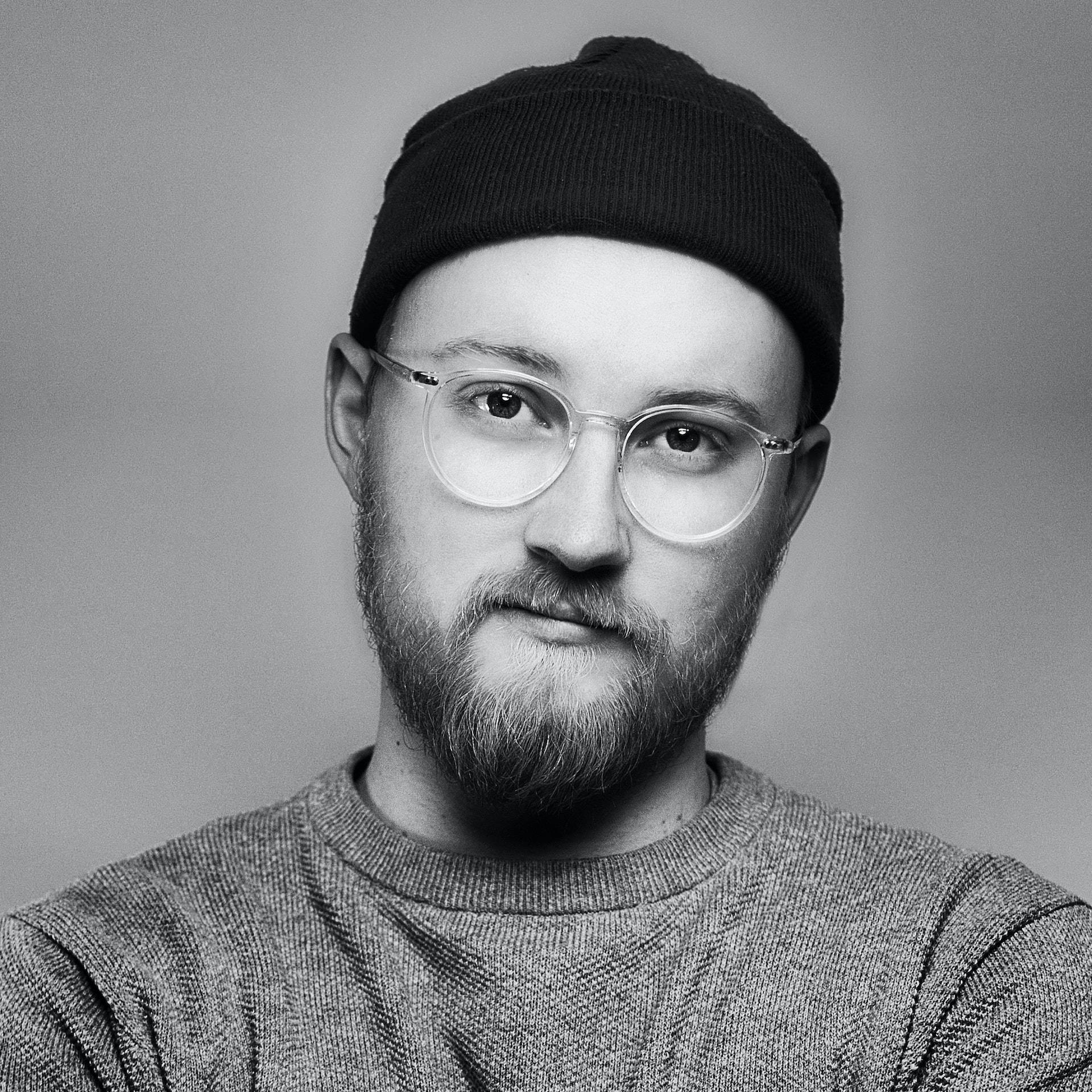 Striking Contrast - Man With A Bonnet In Monochrome Background