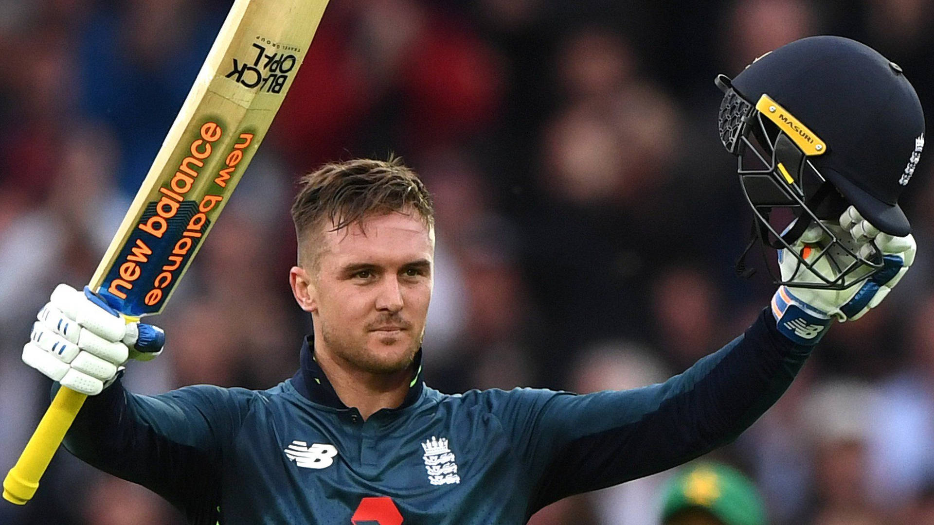 Striking Powerhouse - Jason Roy With Bat And Helmet In Action Background