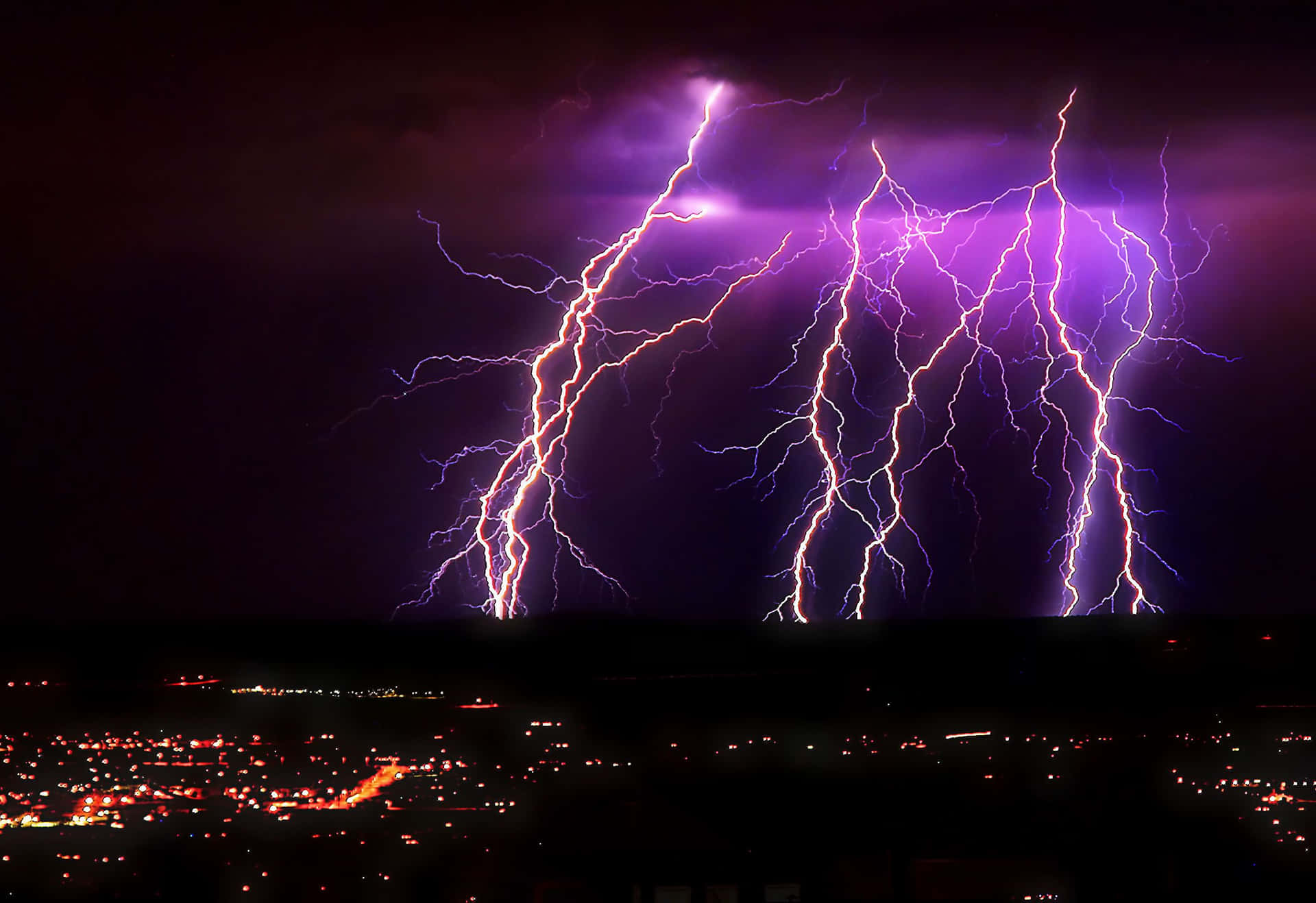 Striking Purple Lightning Over City Background