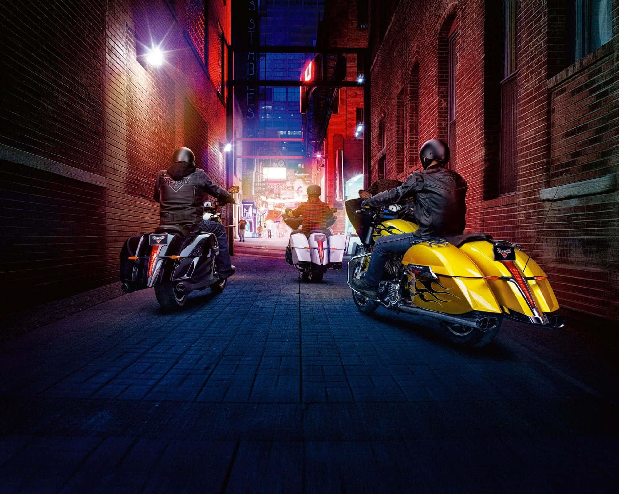 Striking Victory Motorcycle In Nighttime Cityscape Background