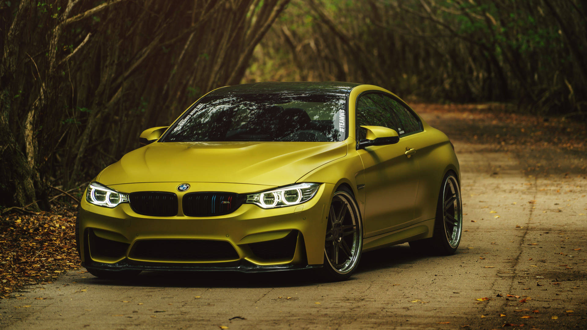 Striking Yellow Bmw M Series In Action Background