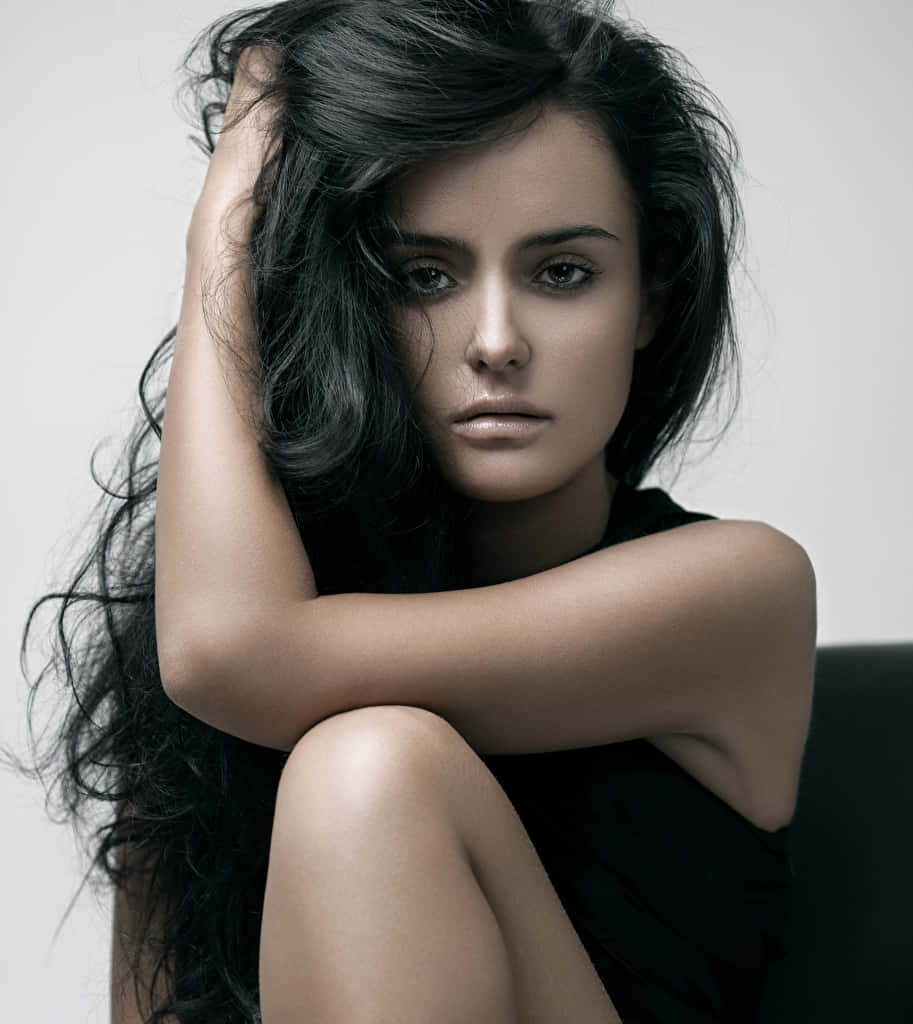 Striking Young Female Model With Curly Black Hair Background