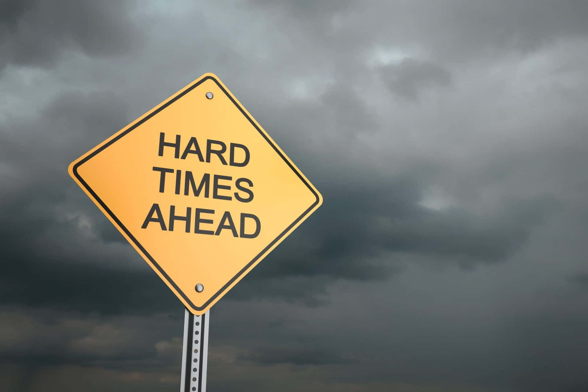 Struggle And Resilience: Arduous Times Sign Against Wilderness Backdrop Background