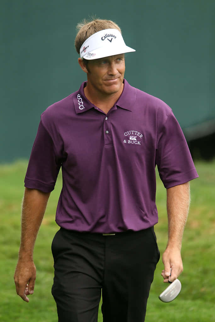 Stuart Appleby Confidently Walking On The Golf Course With A Radiant Smile. Background