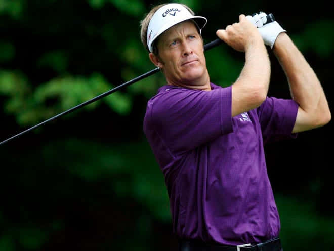 Stuart Appleby Holding A Golf Club Background